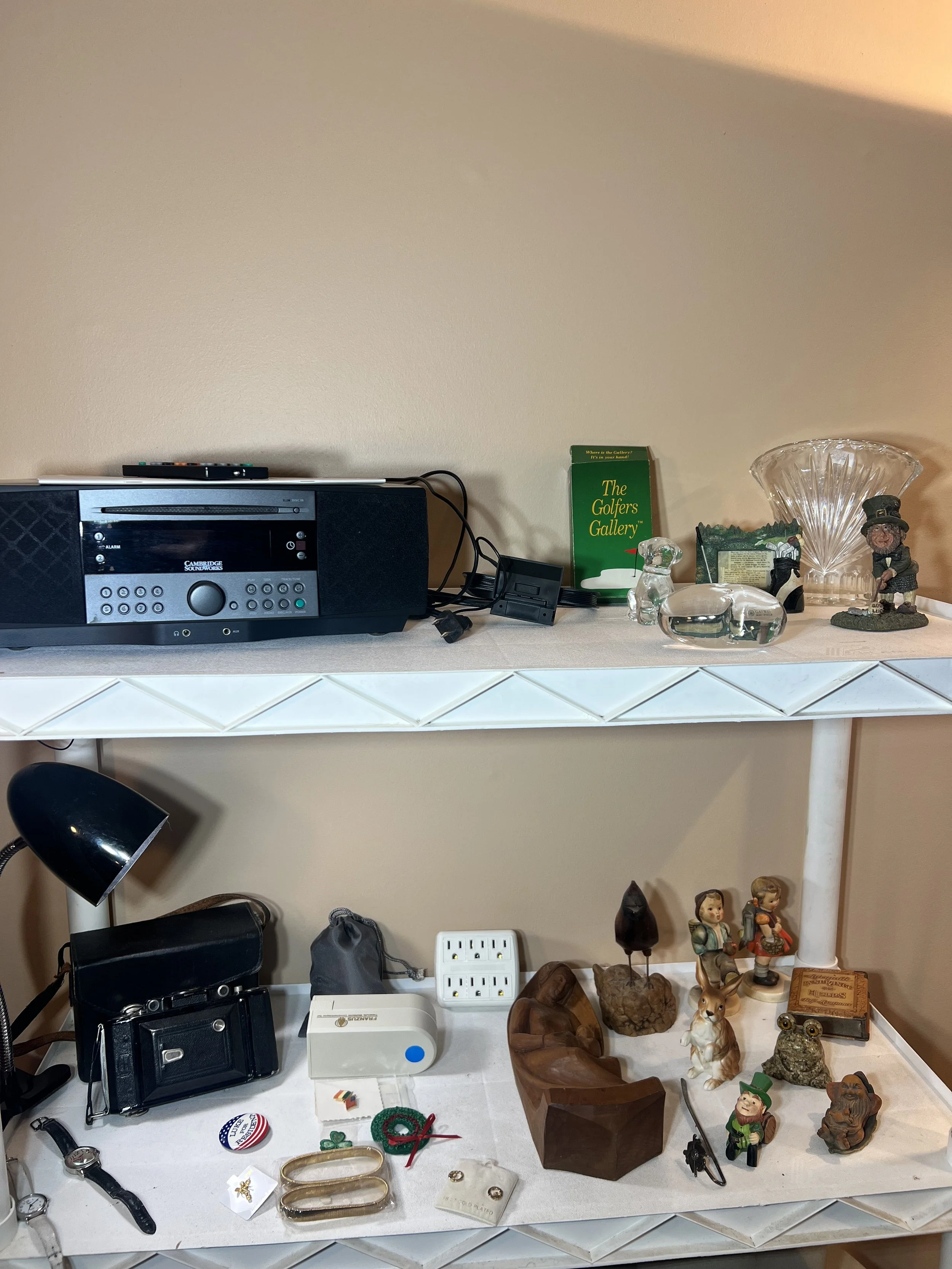 Audio & Small Collectibles – Cambridge SoundWorks radio/CD player, Hummel-style figurines, vintage camera, and crystal decorative accents