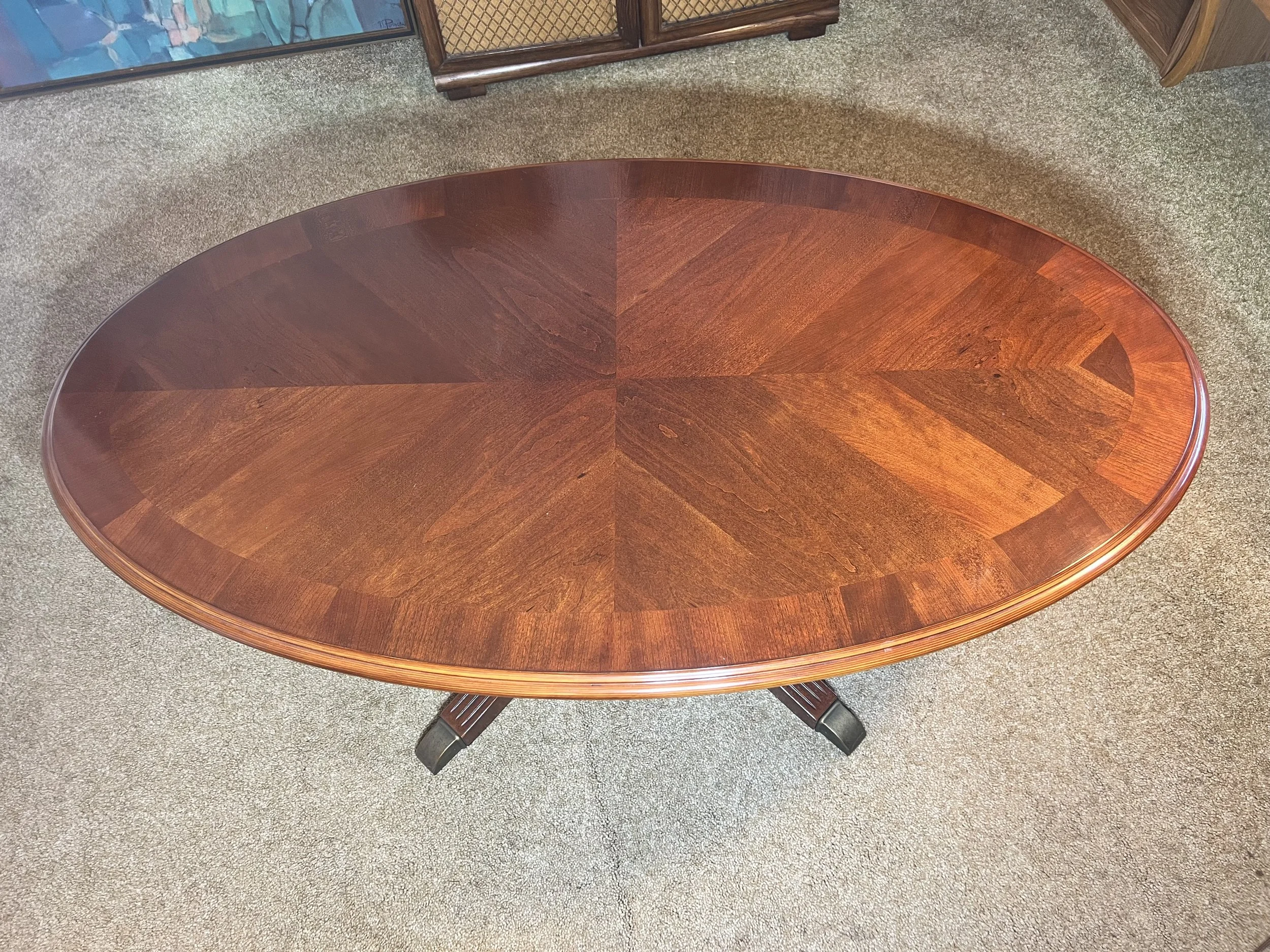 High-quality wood oval coffee table featuring a beautiful sunburst veneer pattern