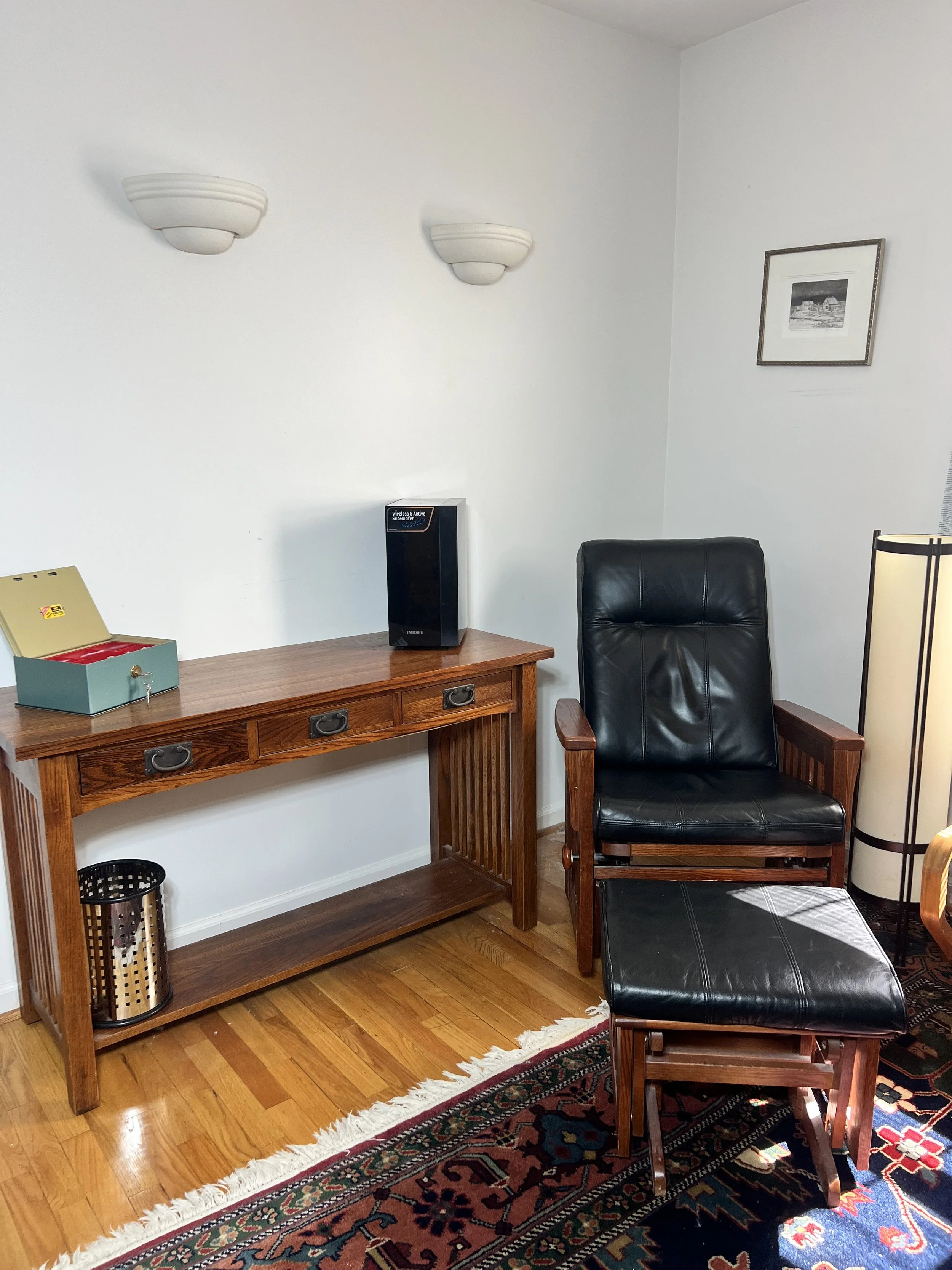Michaels of Sacramento 3-drawer console table. A black leather glider chair