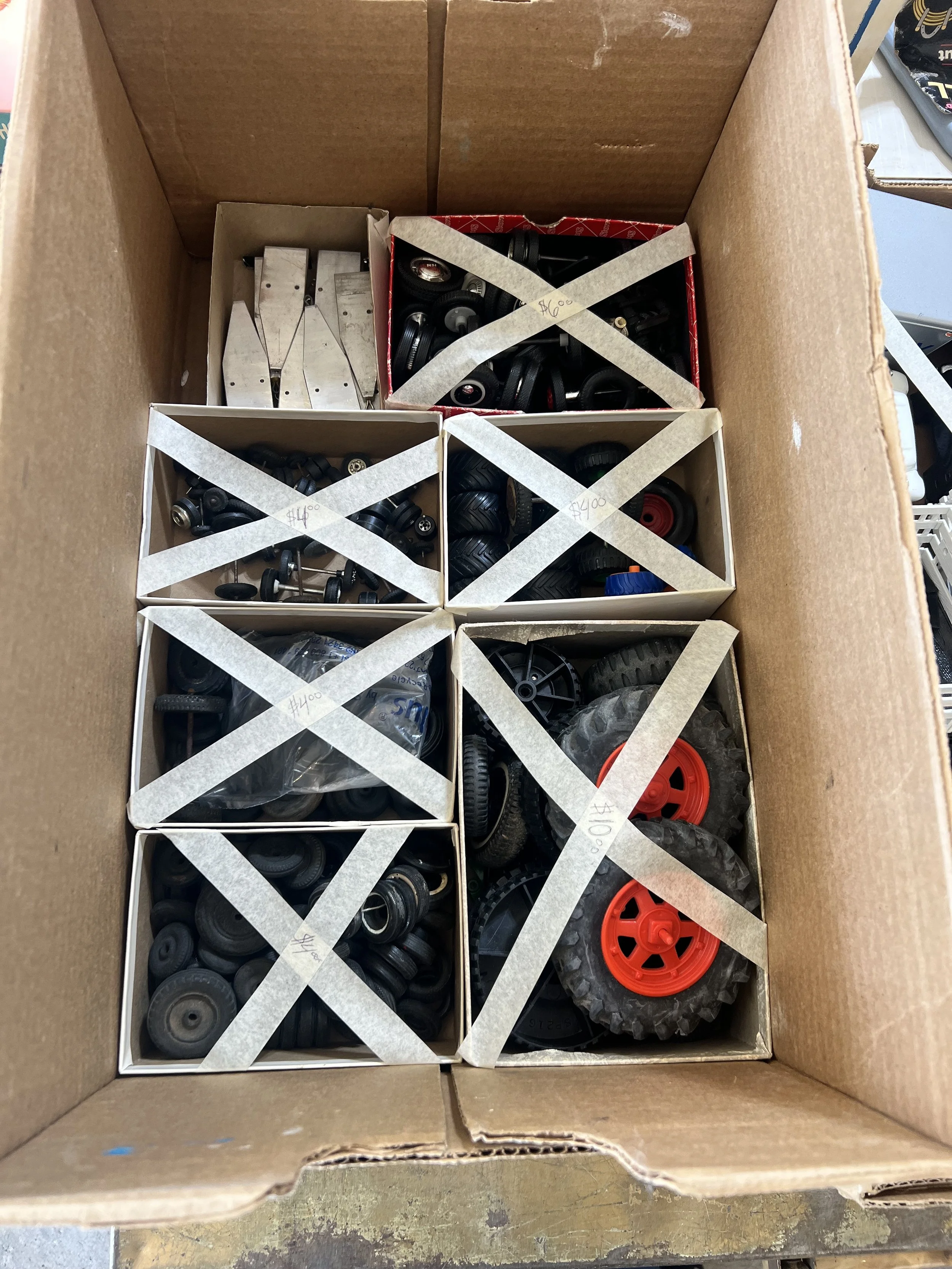 Boxes of vintage toy wheels and replacement tires for pressed steel and die-cast restoration projects
