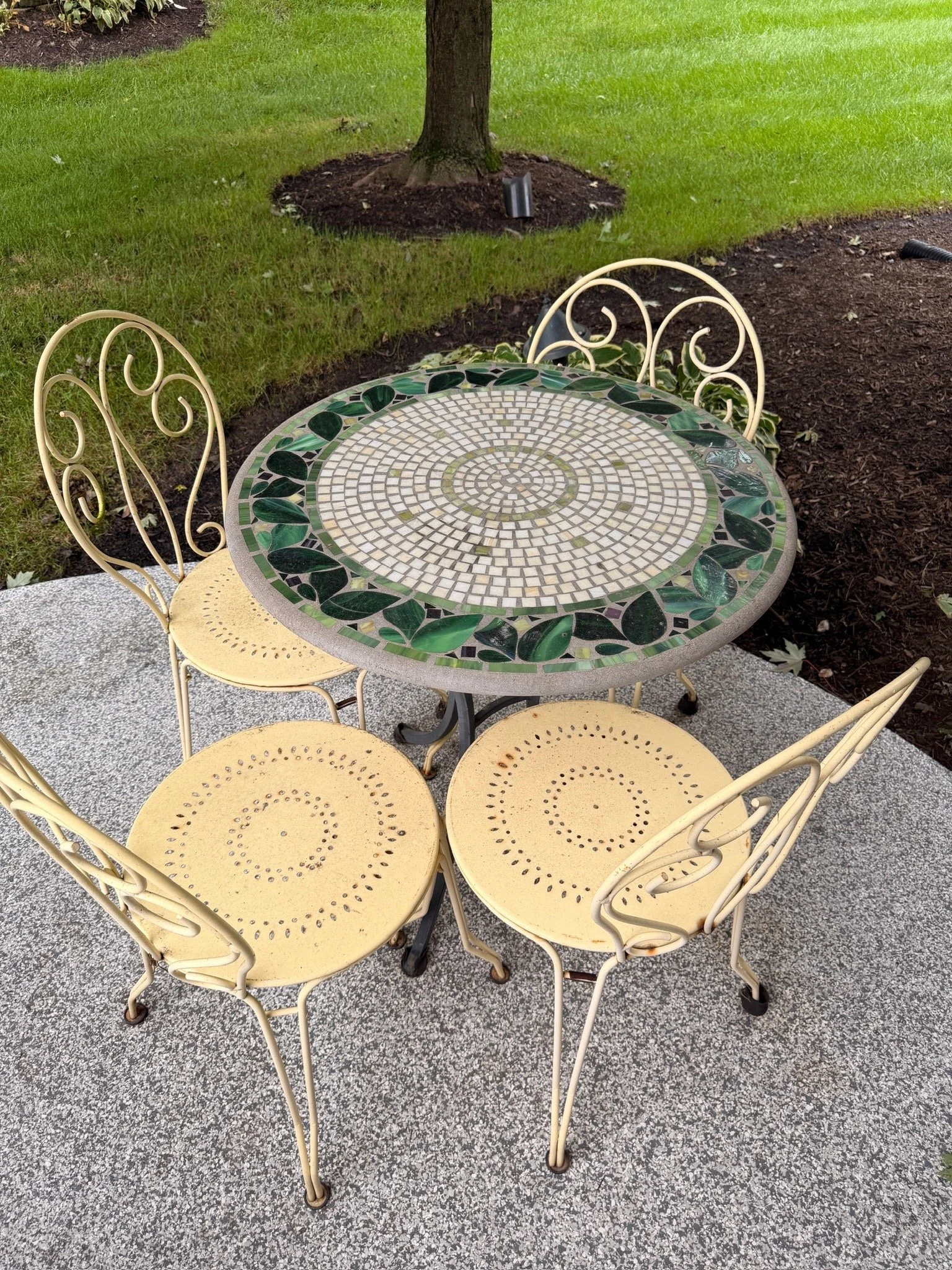 Mosaic garden table and four metal chairs