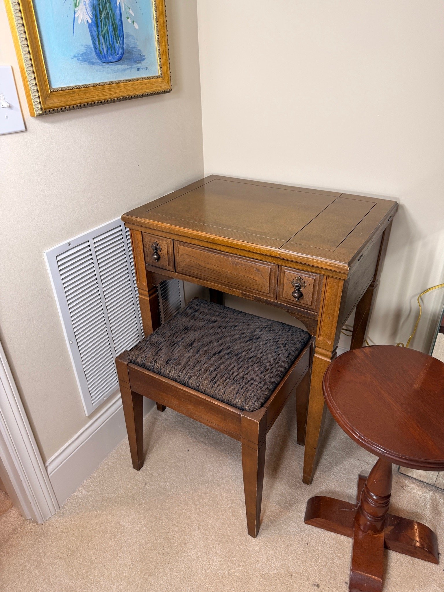 Vintage Singer sewing machine in folded wooden cabinet