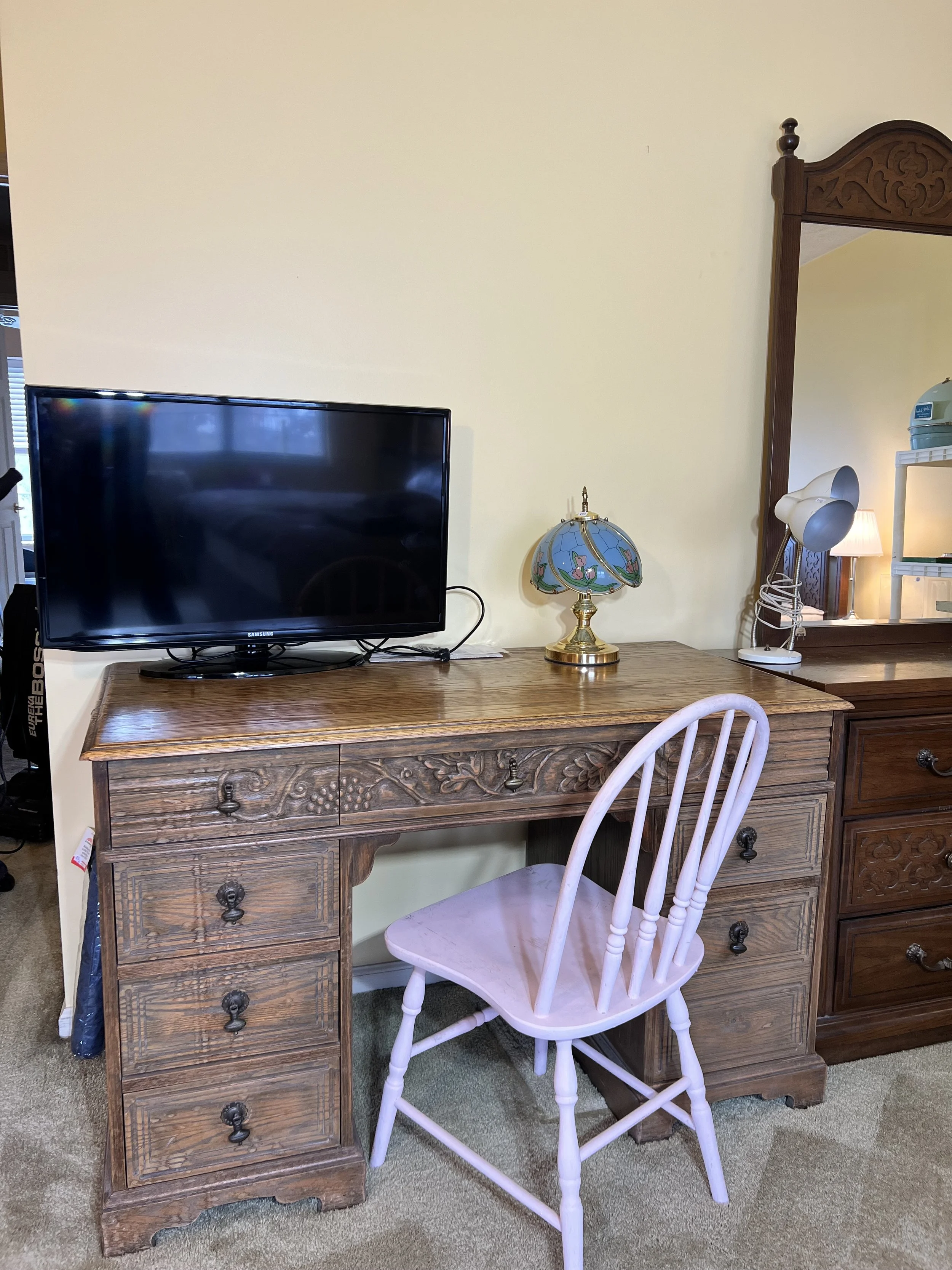 Flat screen TV, carved desk, chair, lamps