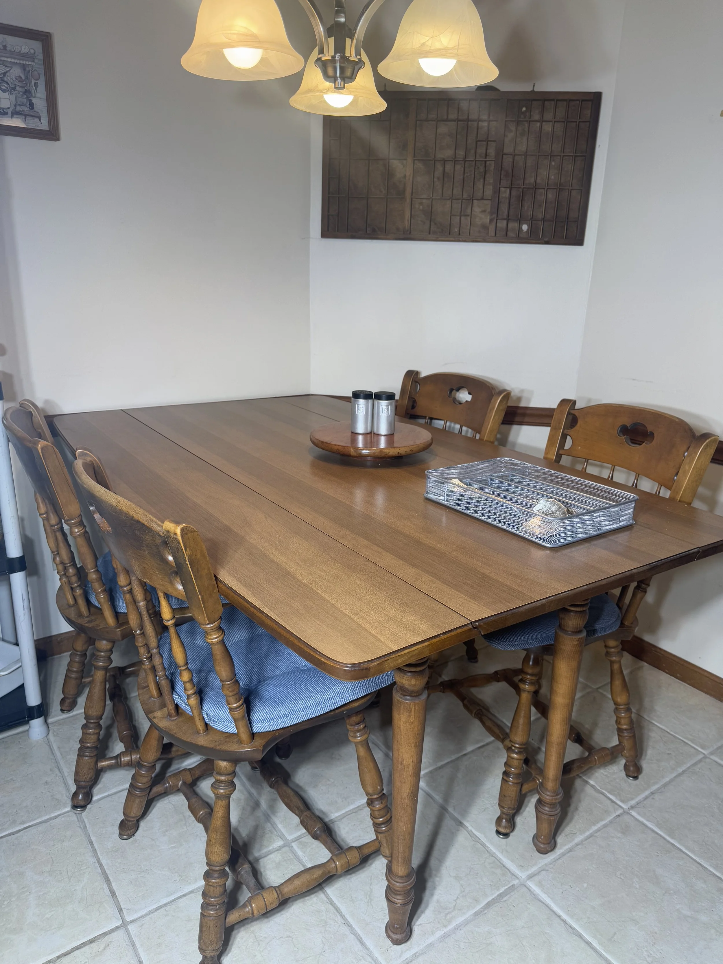 wooden drop-leaf dining table with 4 spindle-back chairs