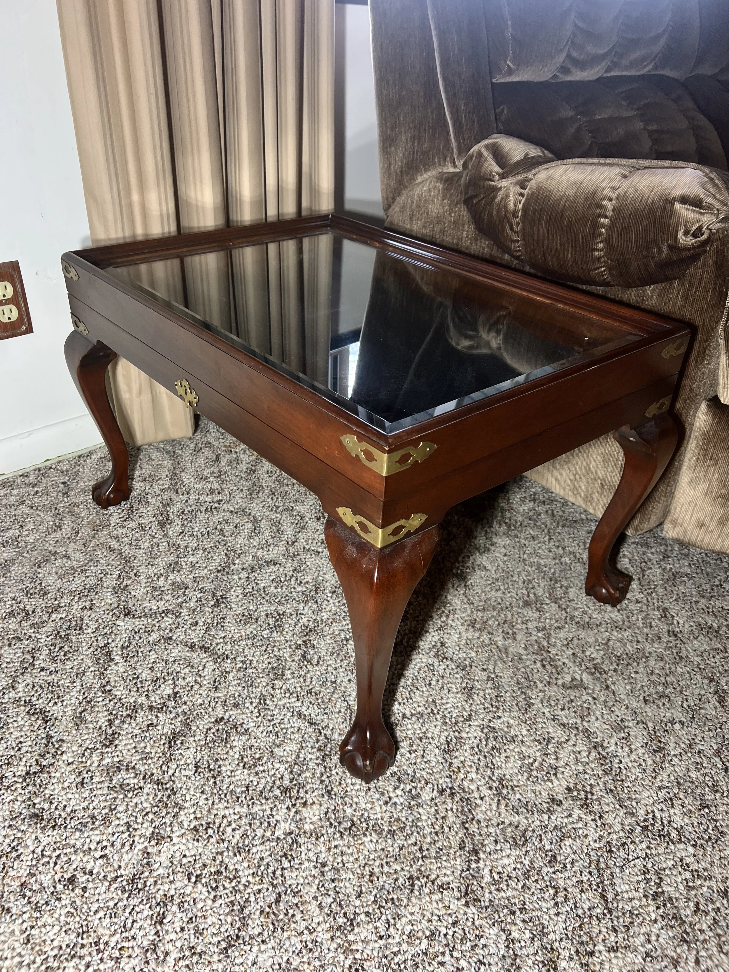 Sleek Mission-style sofa table with glass-top panels and a center storage drawer
