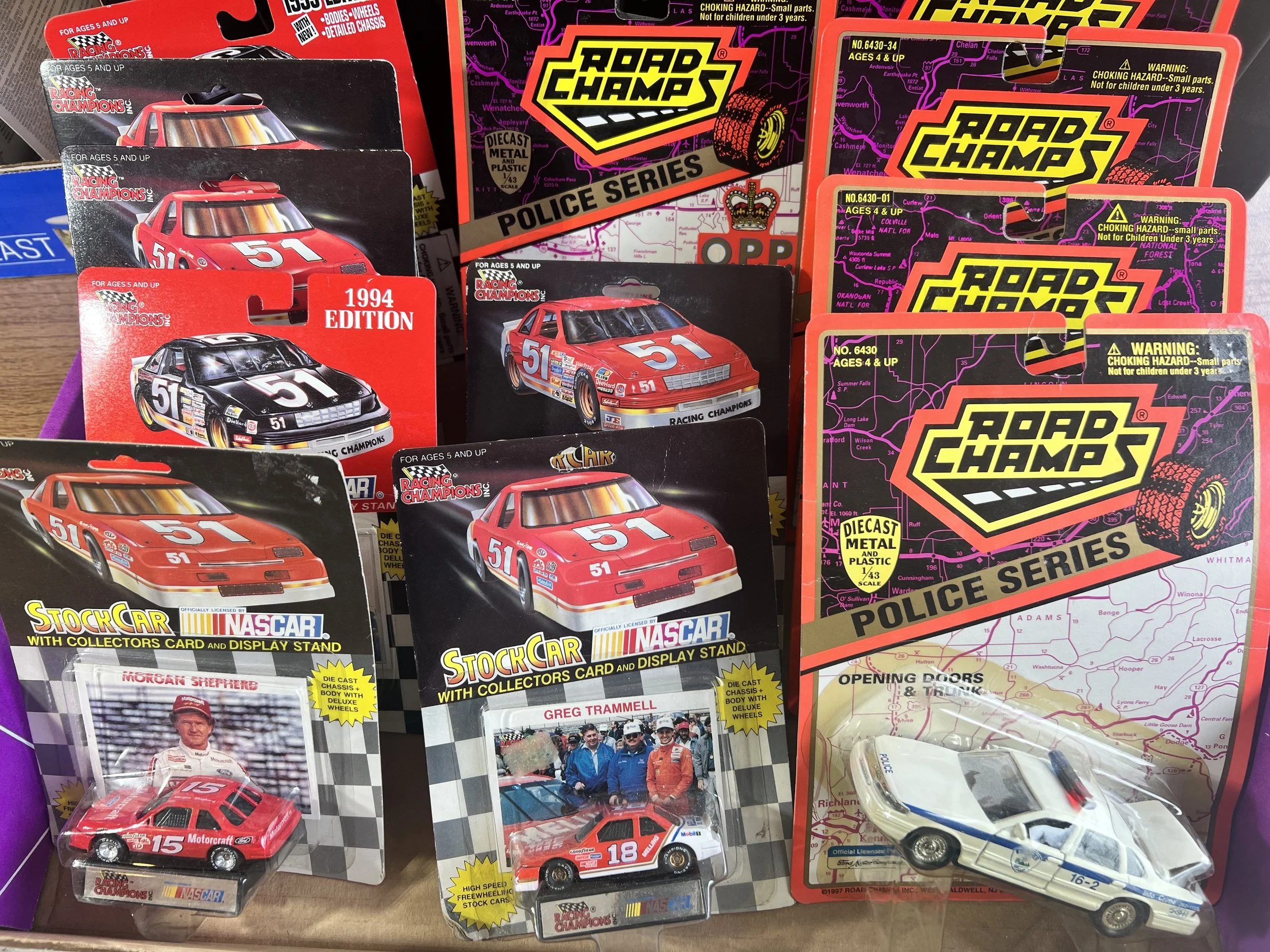NASCAR & Racing Champions – Racing Champions and NASCAR die-cast stock cars, featuring the 1994 and 1995 editions with collector cards and display stands