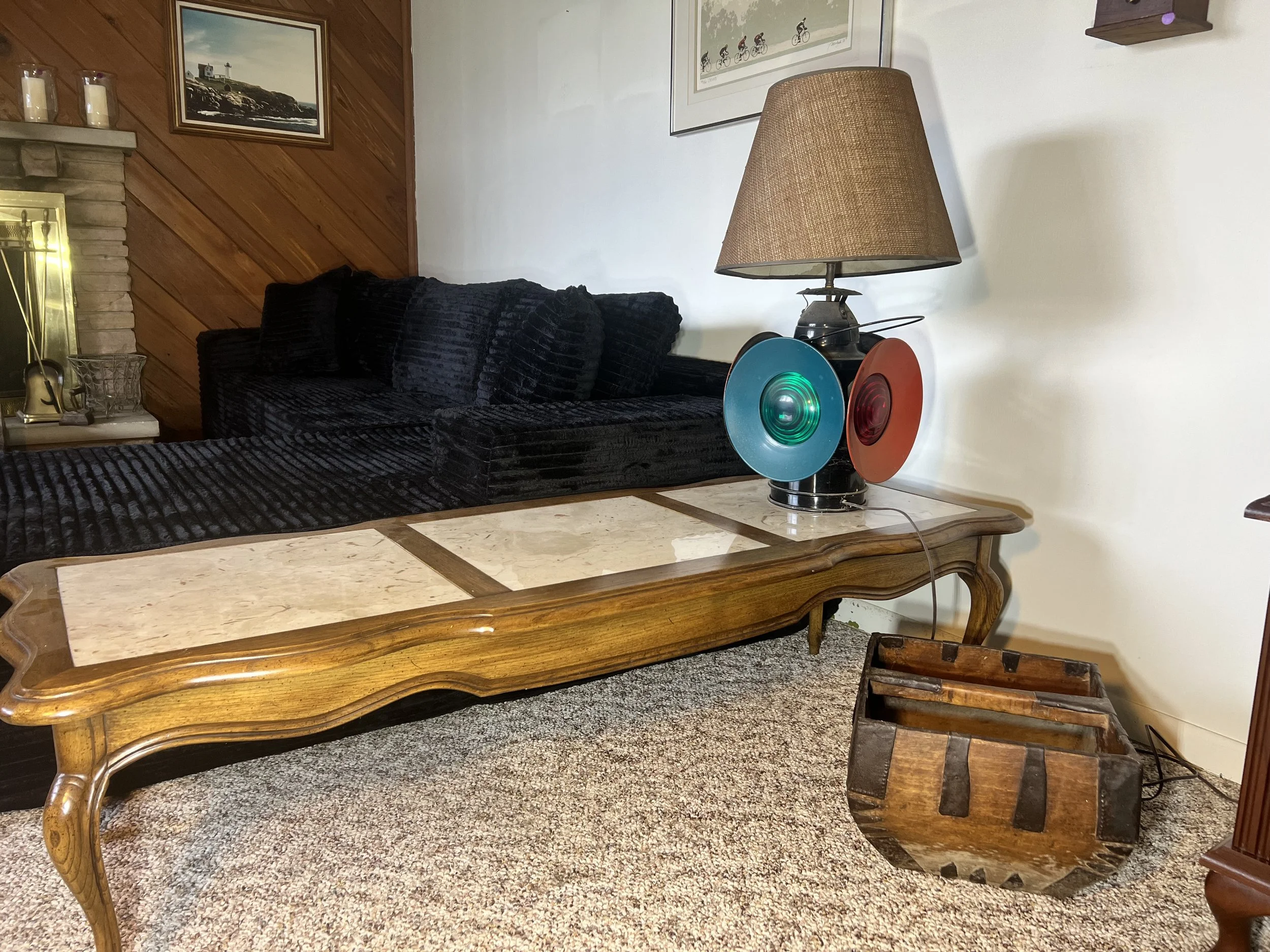 Long wood-framed coffee table with three inset marble panels and elegant cabriole legs