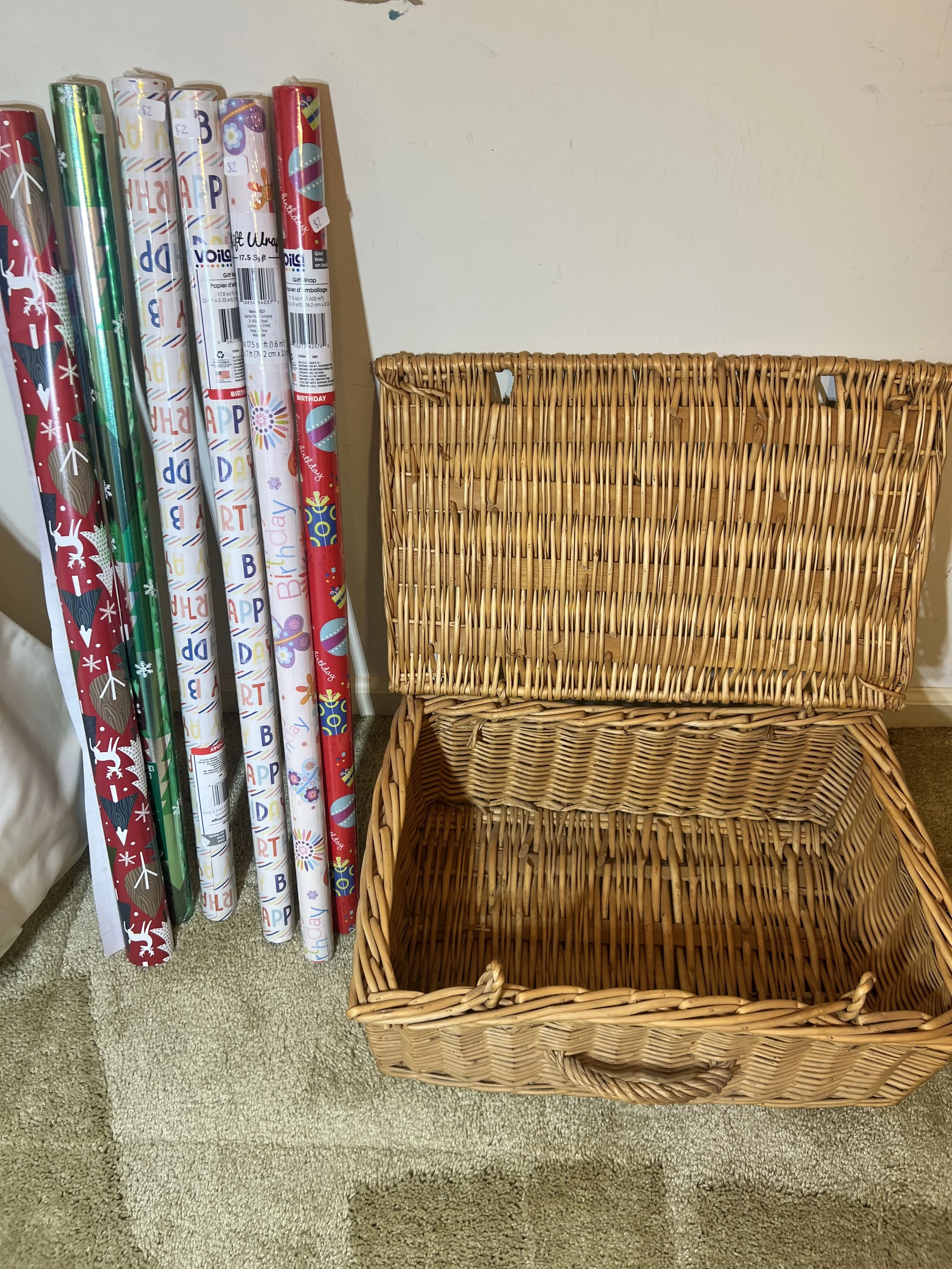 Large, vintage woven wicker hamper/trunk and assortment of birthday and holiday gift wrap