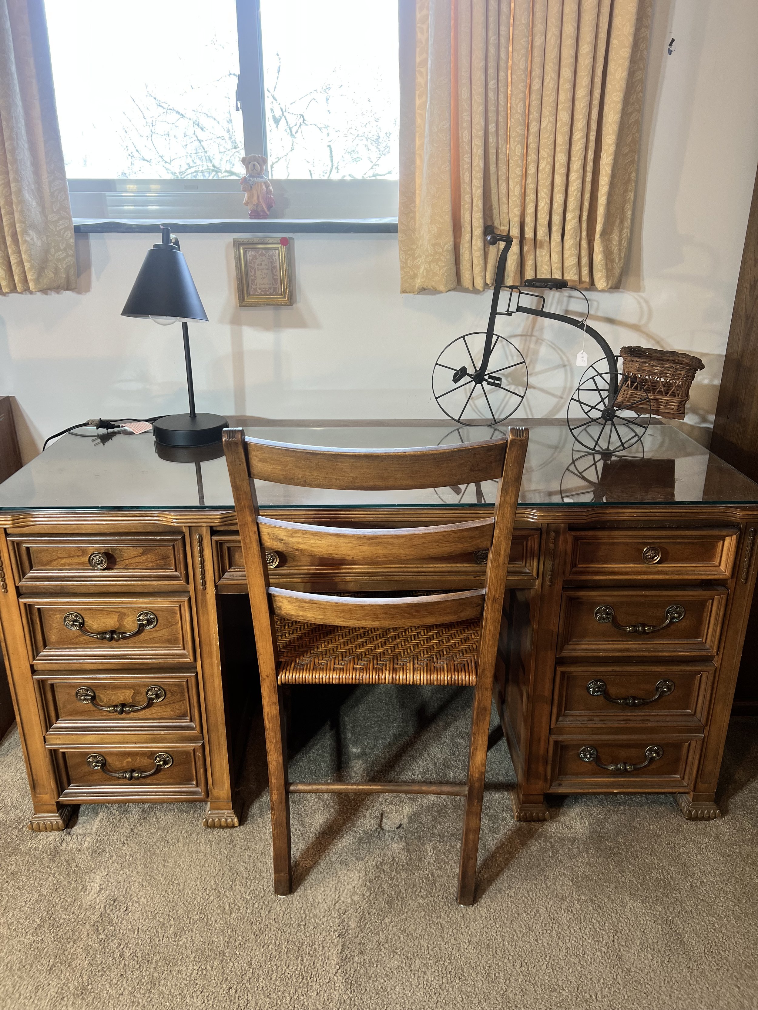 Classic executive wooden desk with a glass top, paired with a matching ladder-back chair