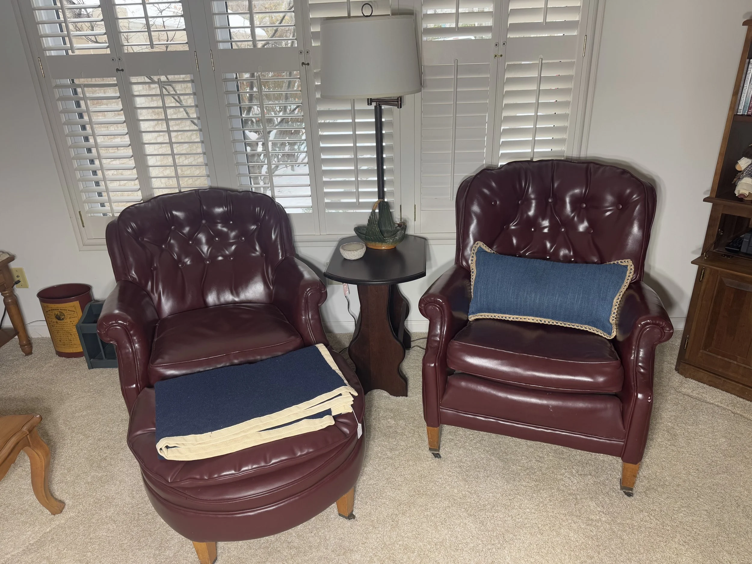 his and hers vintage burgundy tufted leather armchairs with ottoman 