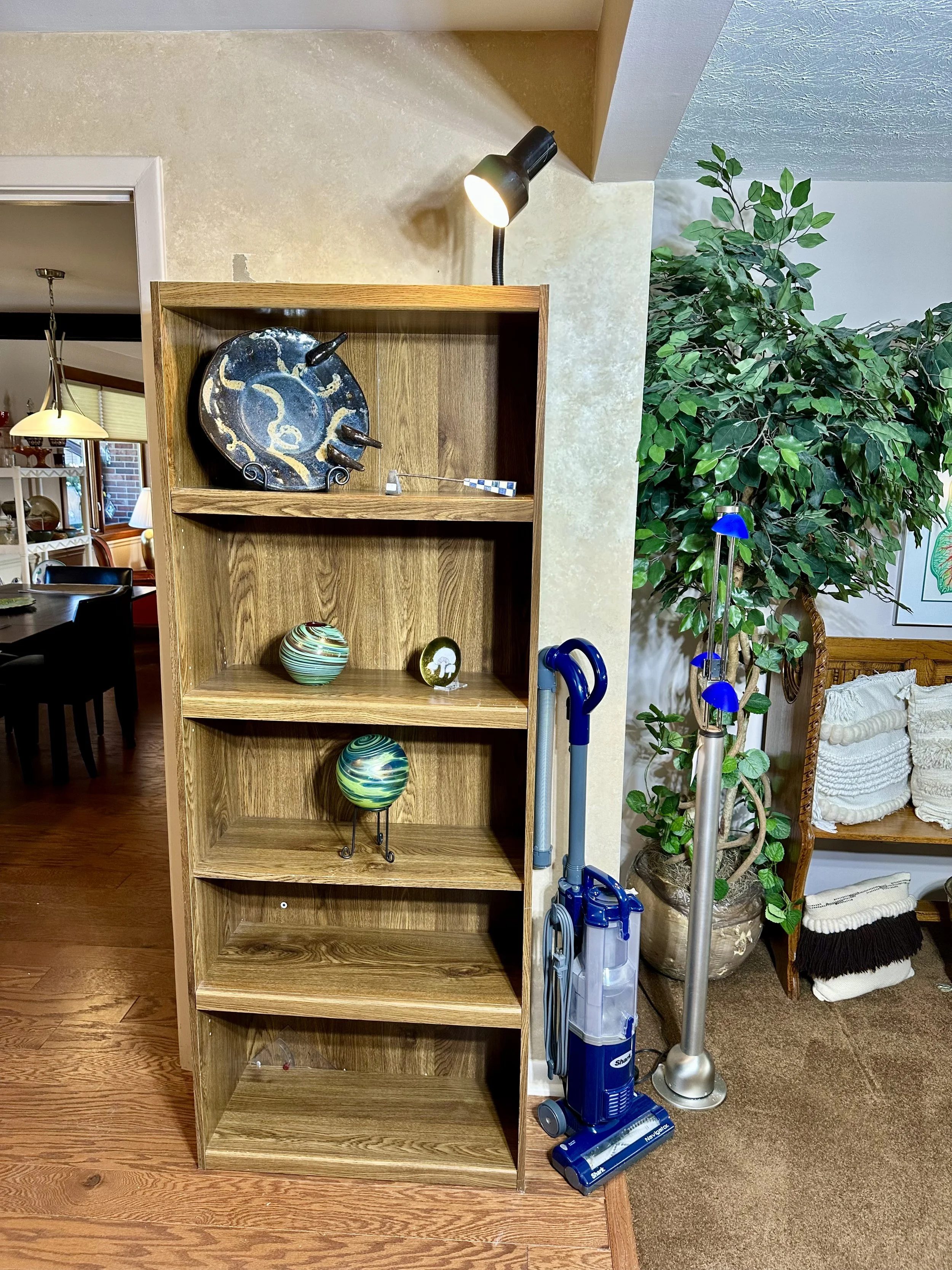 various decorative glass, bookcase, and vacuum