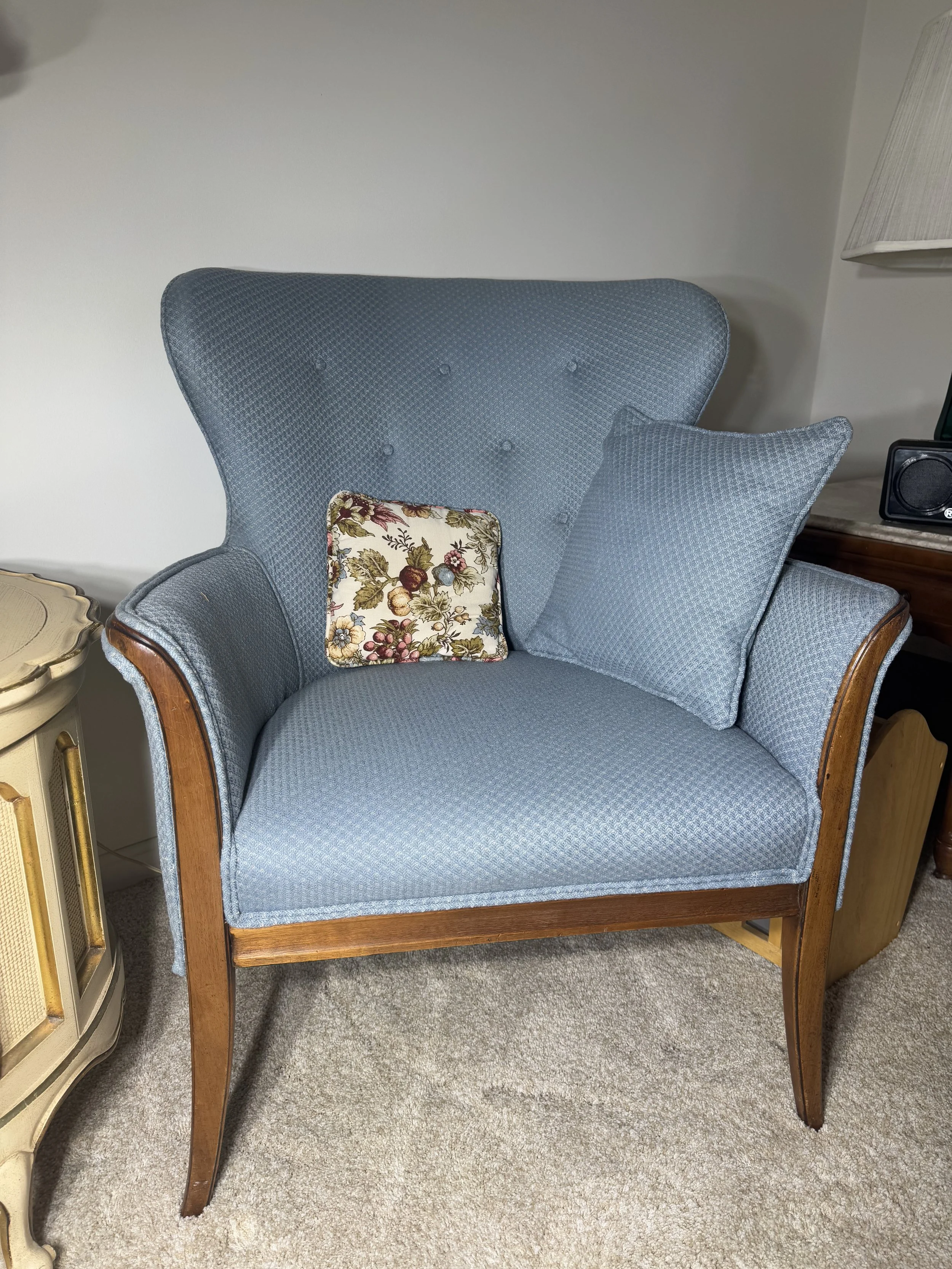 vintage wood-frame wingback chair