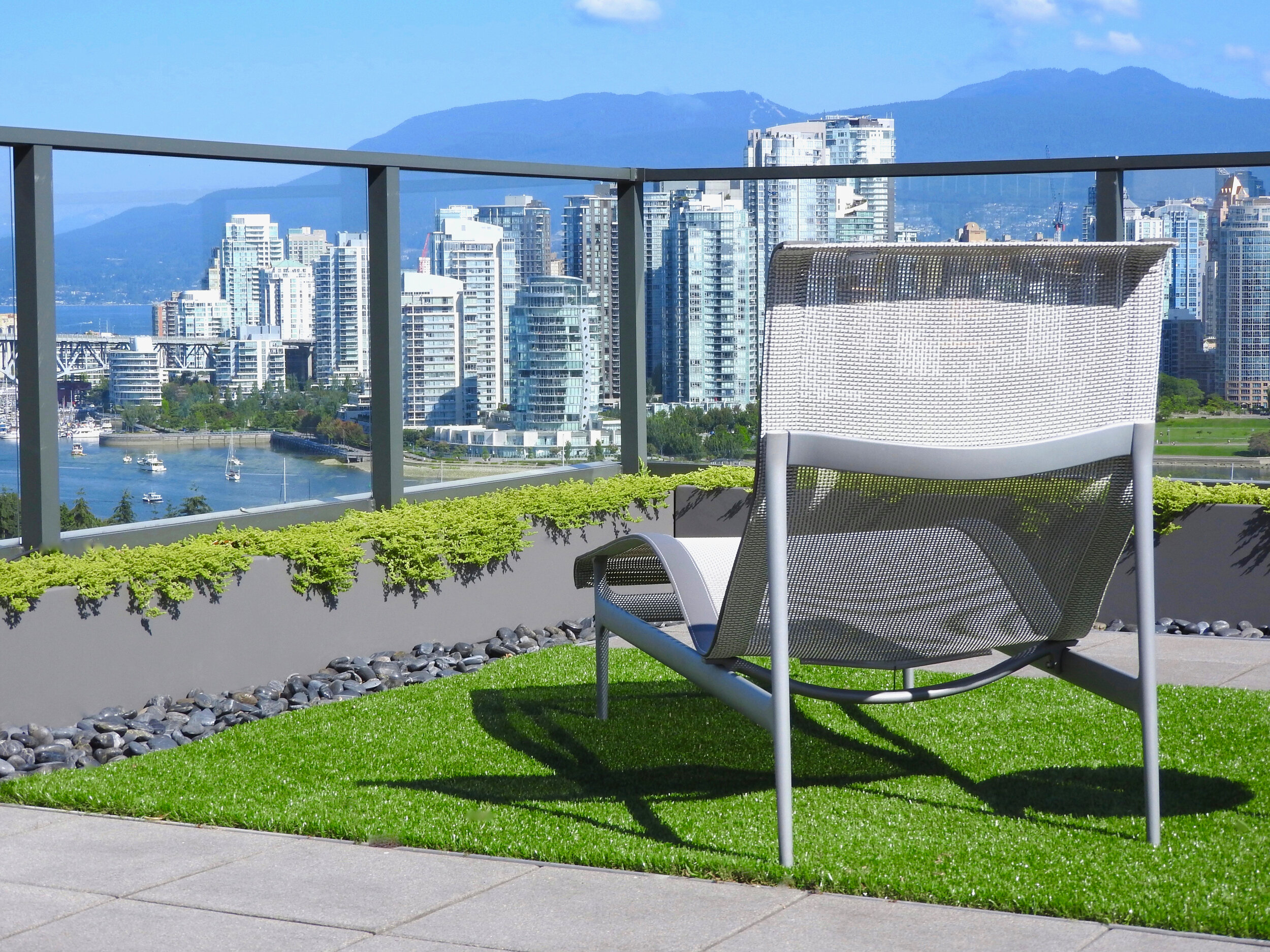 Powder coated aluminum partition planters on a rooftop patio