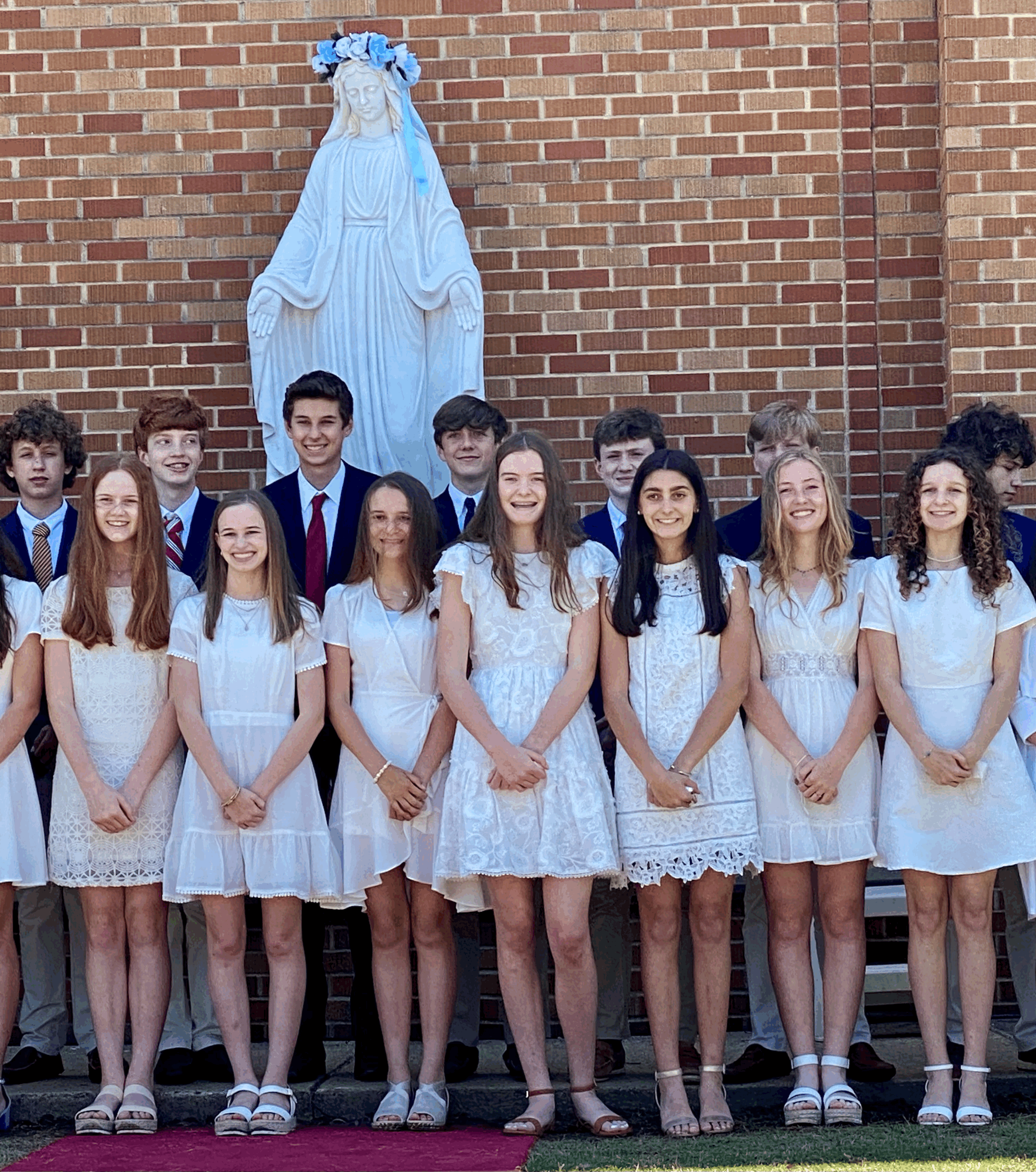 Each year, the school celebrates ‘May Crowning of the Blessed Virgin Mary’ and every child in the school places a rose at the feet of Mary. There is a strict dress code of Sunday best for most, and white dresses and suits for the graduating Junior High class.