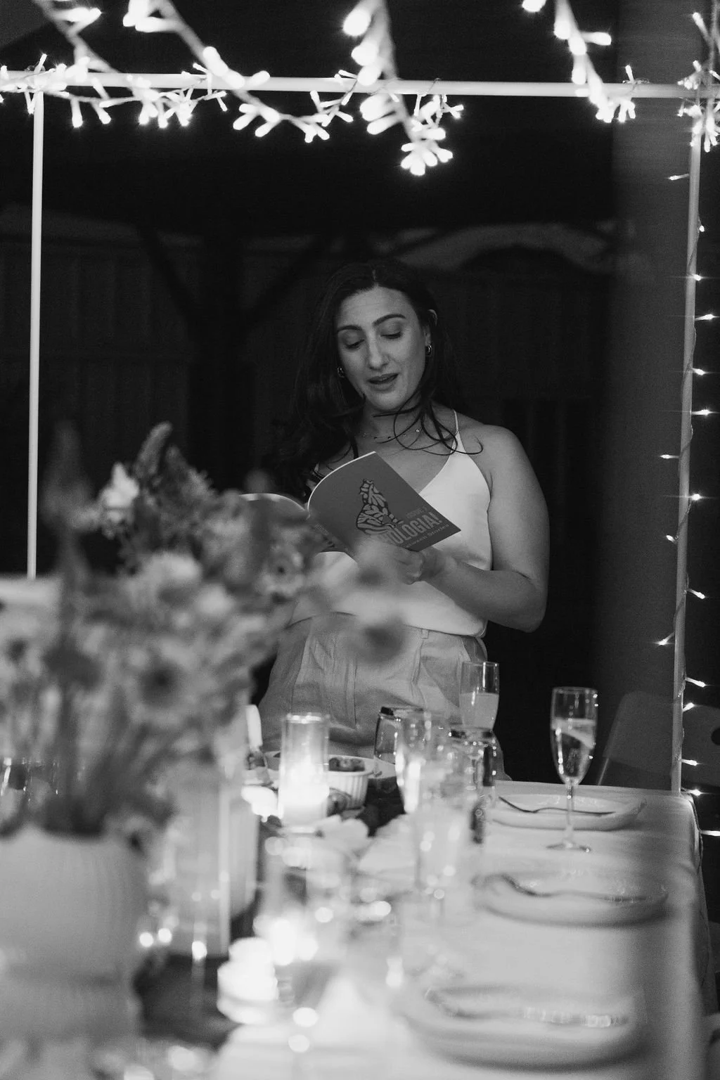 Daniella Elias reading from her book at her book launch in 2024