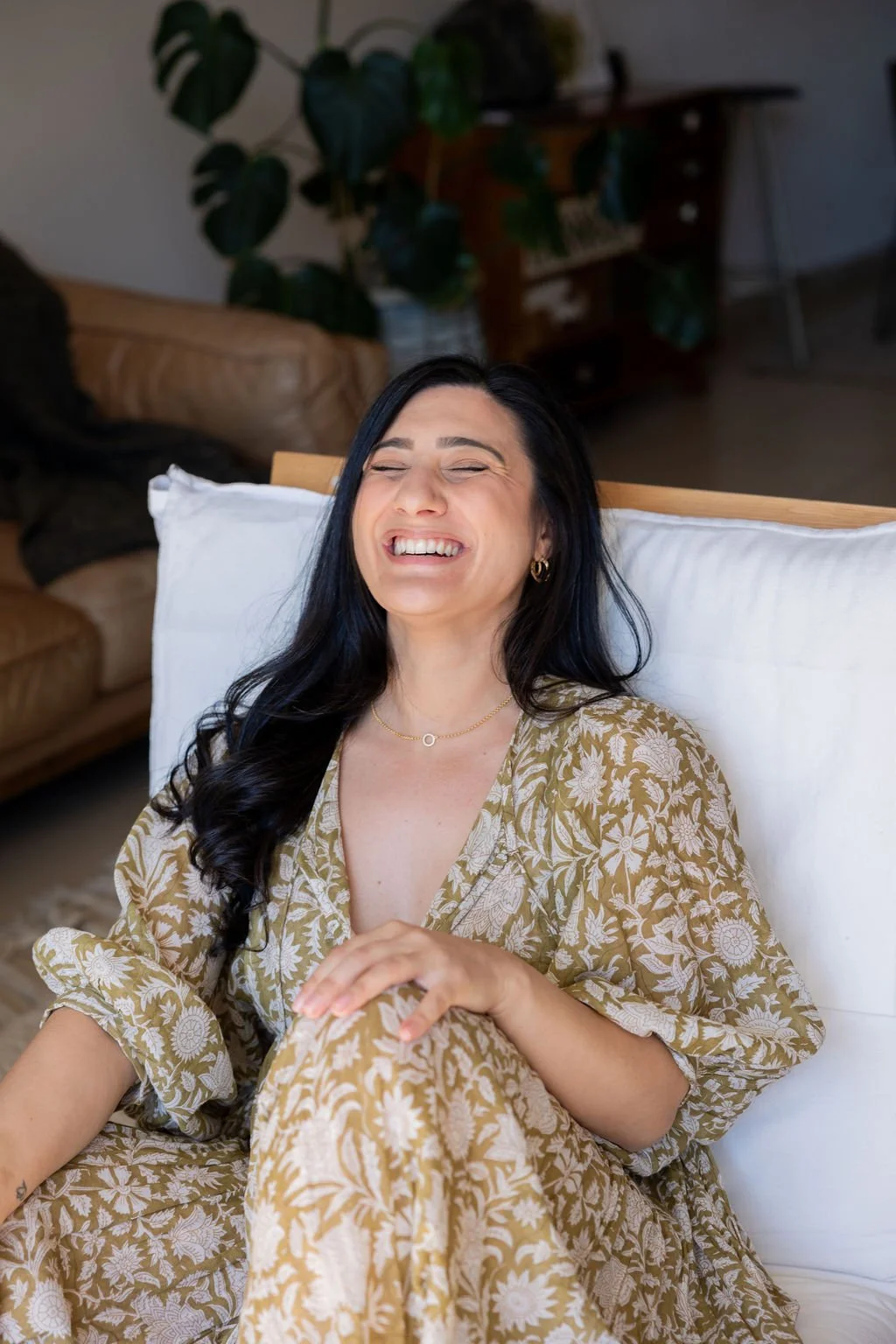 Daniella Elias laughing wearing green dress