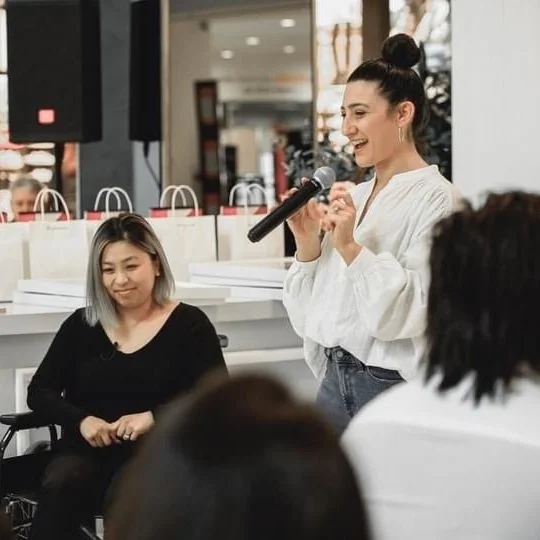 Daniella Elias speaking at an event