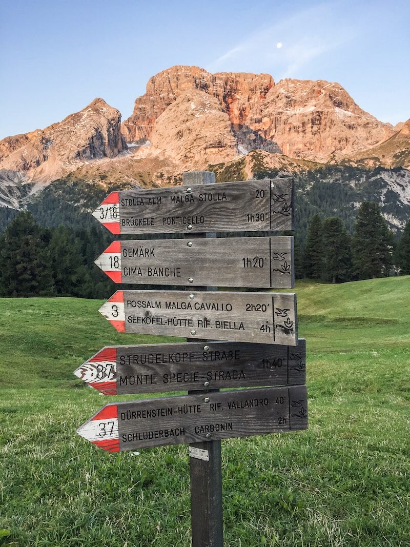Trail sign near Rifugio Prato Piazza with Croda Rosa in the background