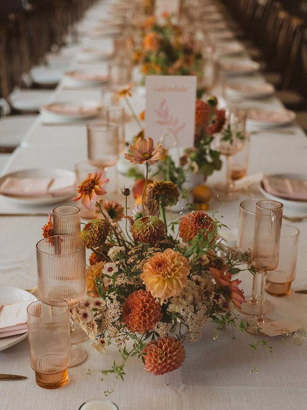 Rose &amp; Cam&rsquo;s reception was held inside the family farm&rsquo;s massive barn, normally used to process and pack freshly cut flowers. The space was transformed with sunny florals all grown by the farm, seasonal fruits, soft linens and citrus 