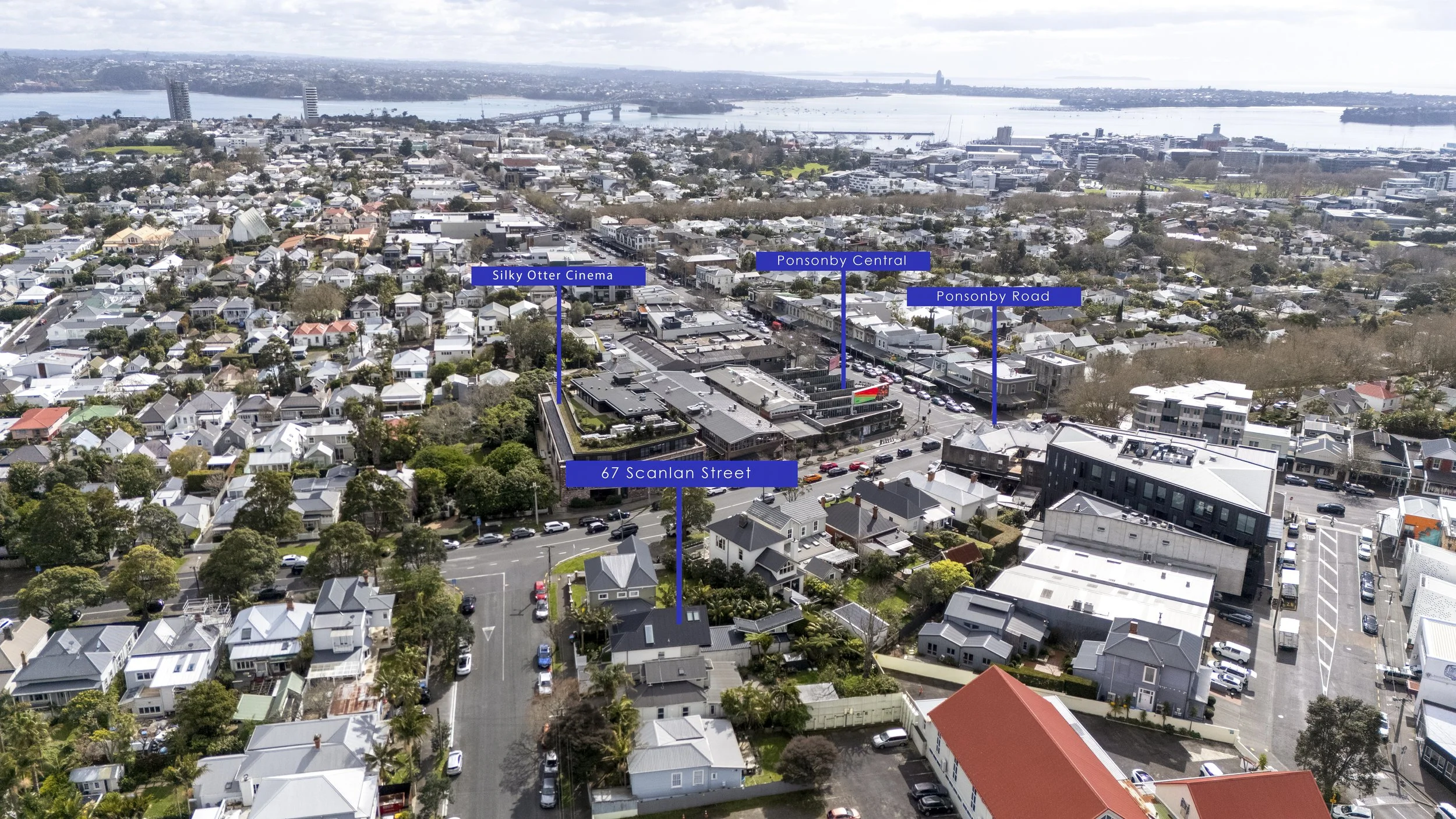 Aerial view of a cityscape with labeled locations including Silky Otter Cinema, Ponsonby Central, Ponsonby Road, and 67 Scanlan Street, showing residential and commercial buildings, streets with cars, and a river in the background.