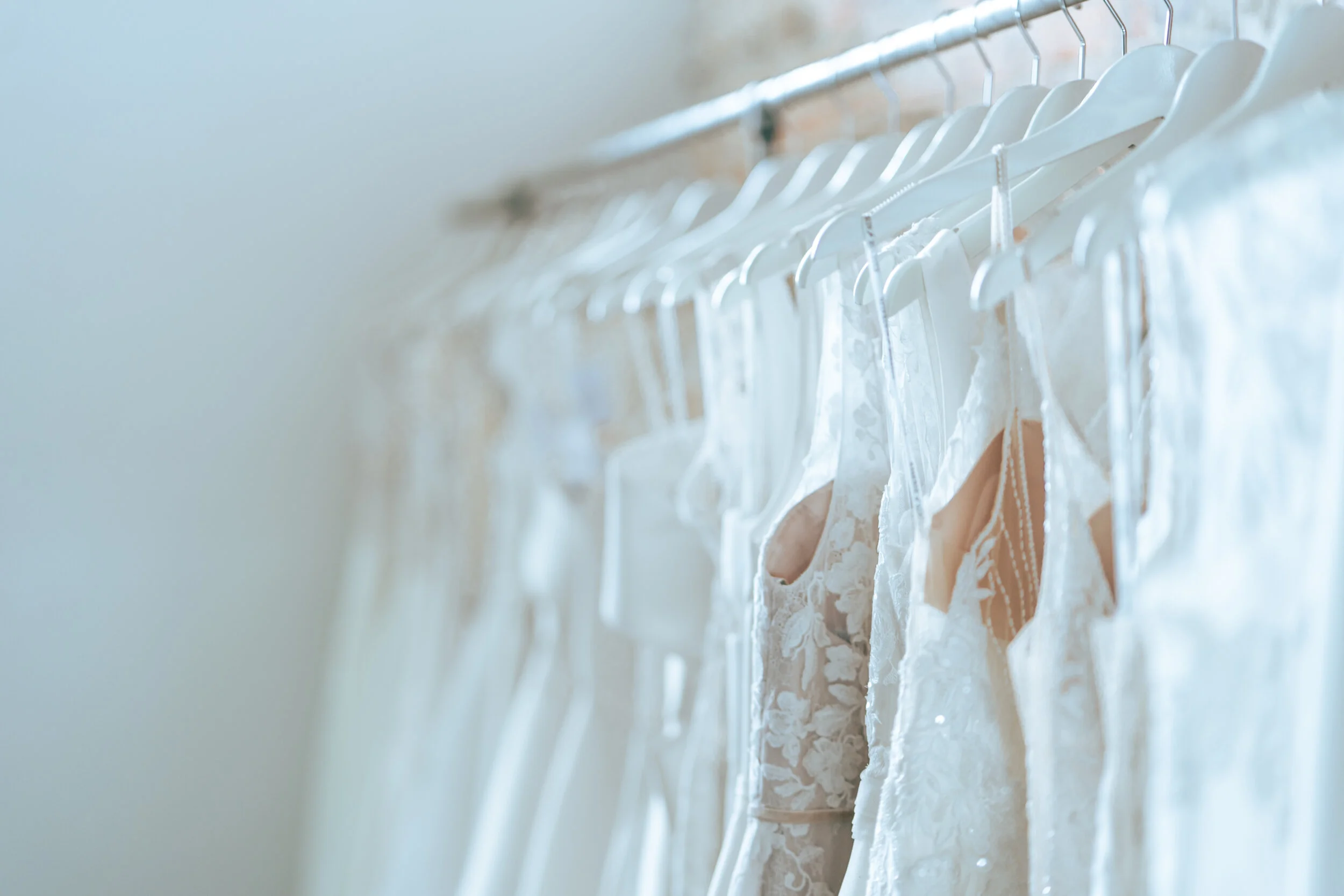 Wedding dresses hanging on a clothing rack