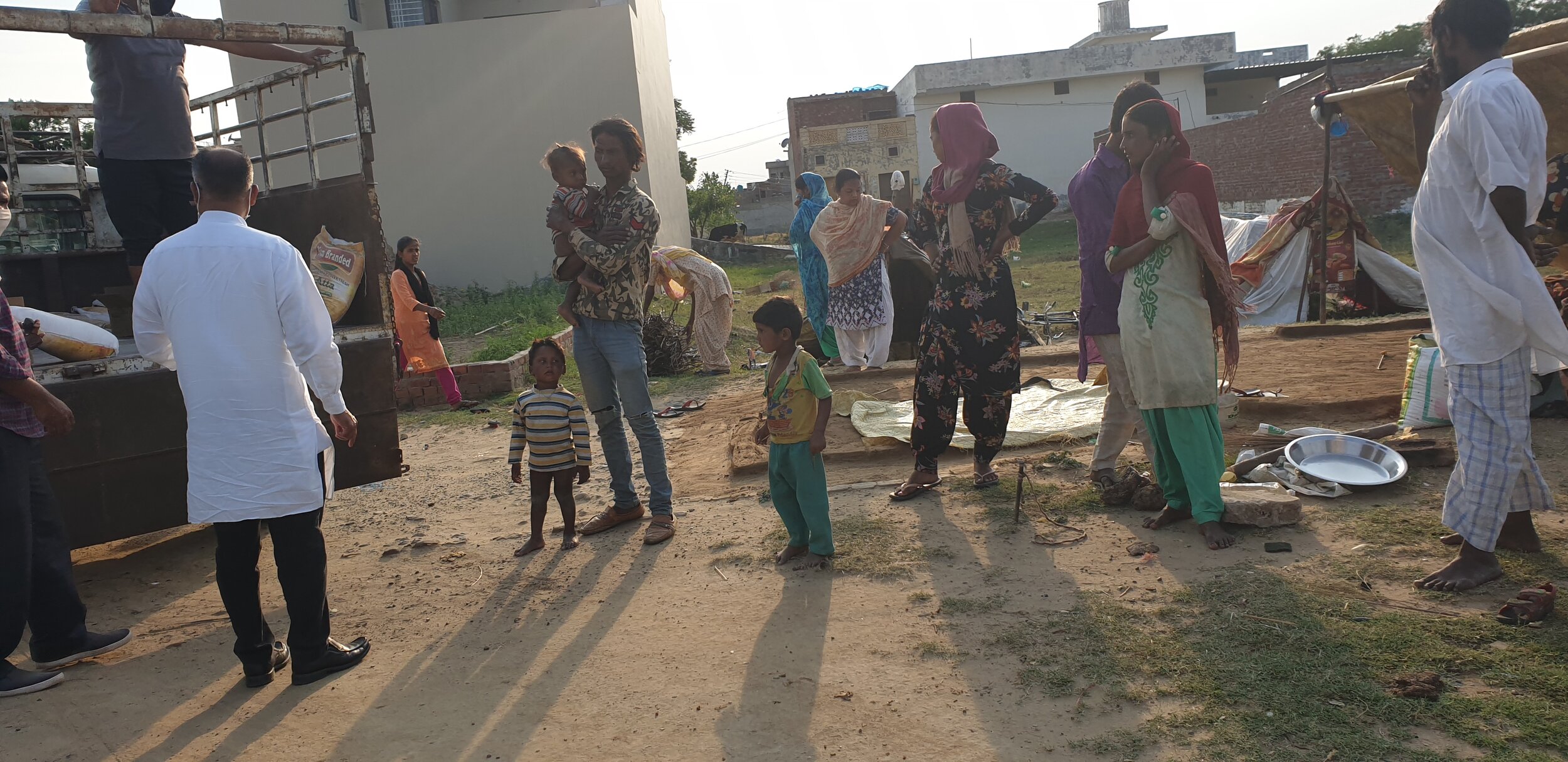 People dwelling in slums lining up to receive groceries during the Covid-19 lockdown period in Punjab.