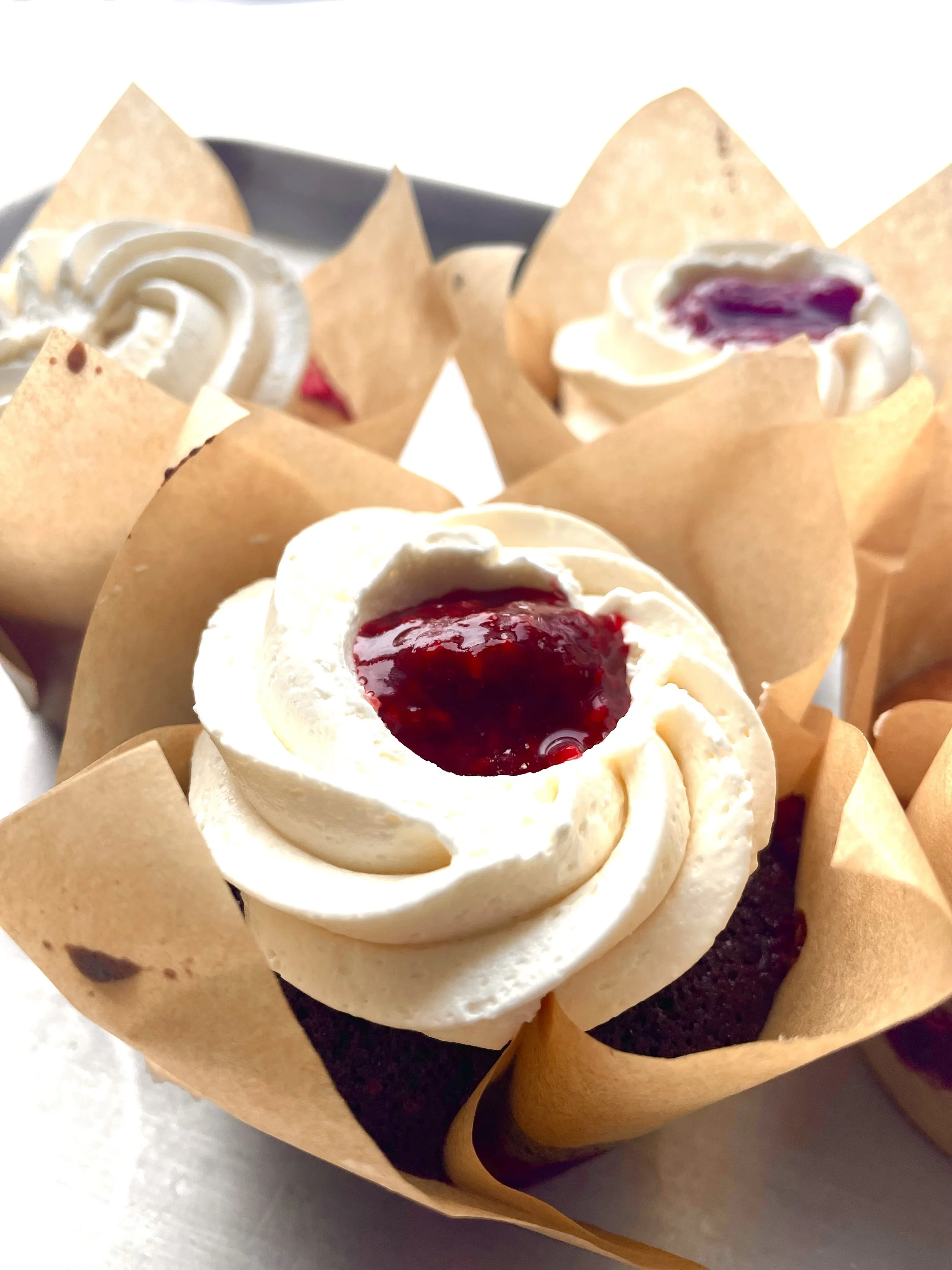 chocolate cupcake with raspberry jam and vanilla buttercream