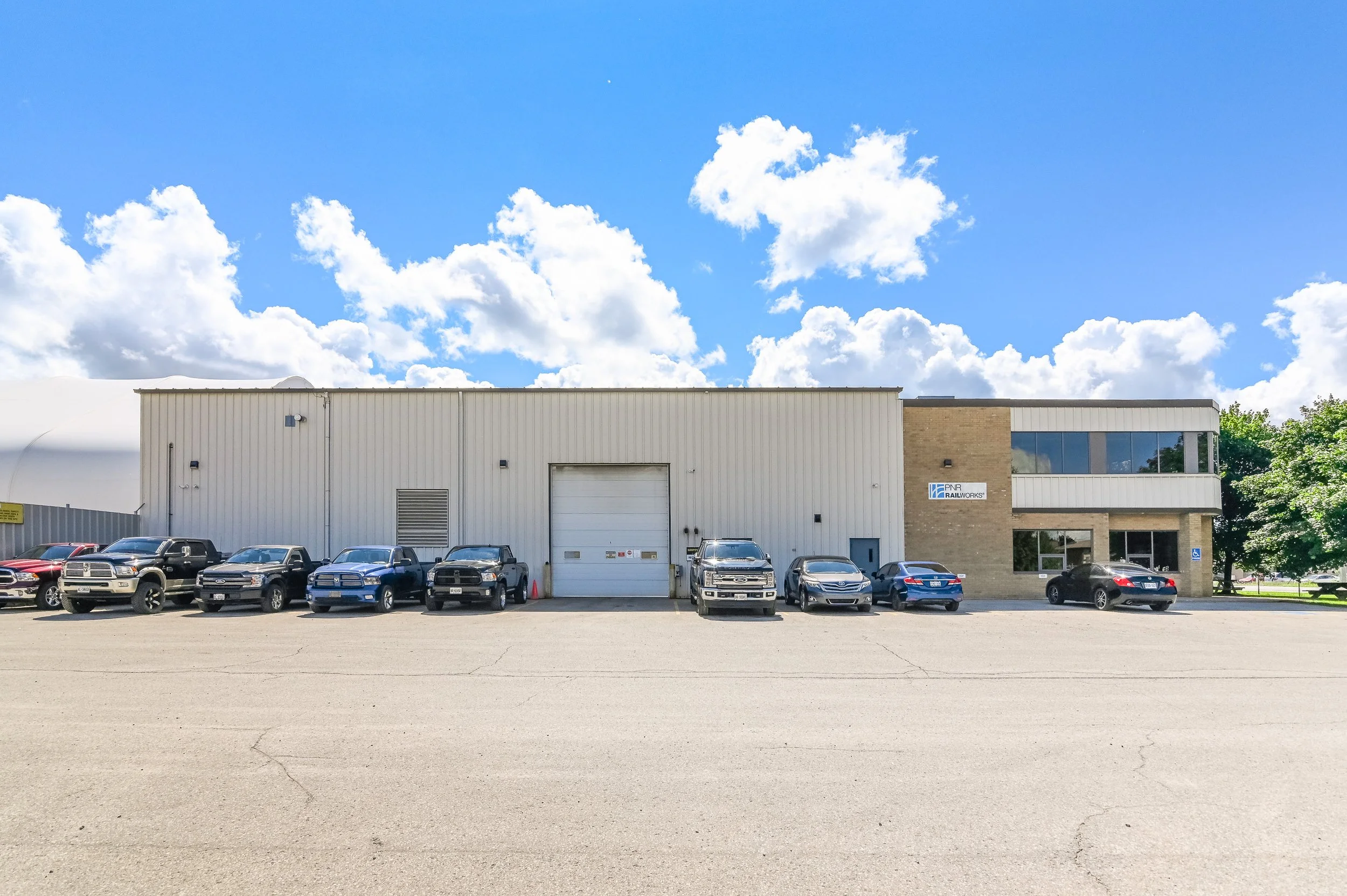 Building at 455 Silvercreek Parkway North with an overhead door and glass entrance