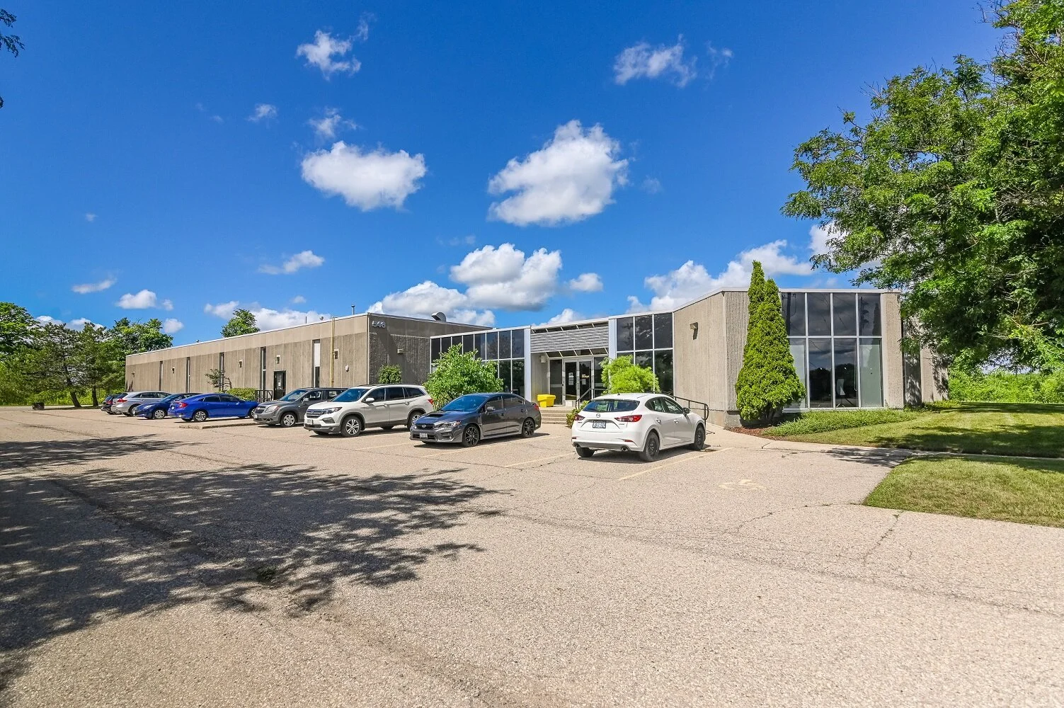 Front right side of 546 Governors Road with parked cars and a pine tree beside the building