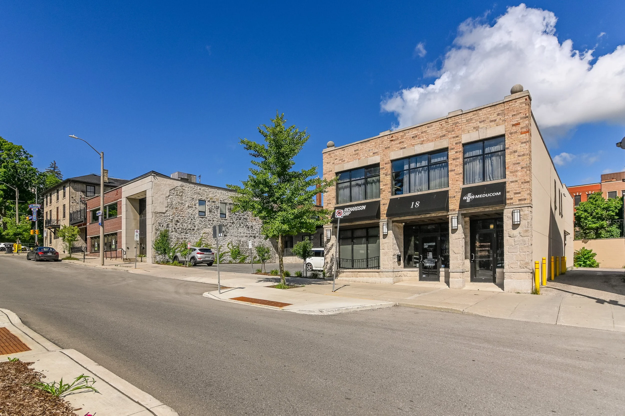 Street view of 18 Macdonell Street, a two-storey brick and stone commercial building