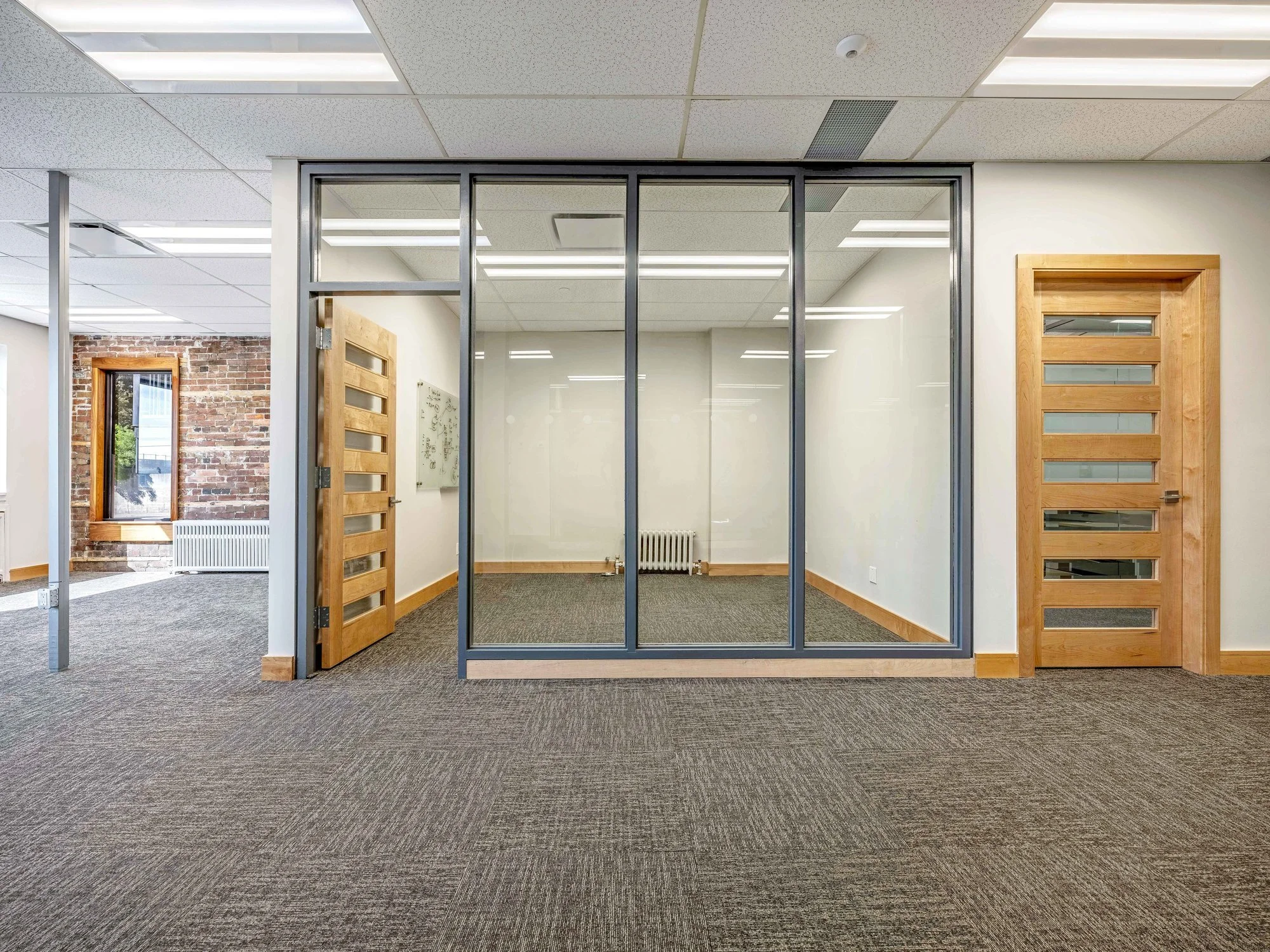 Glass-walled private office and meeting room with wood doors at 8 Macdonell Street, Unit 200A, Guelph