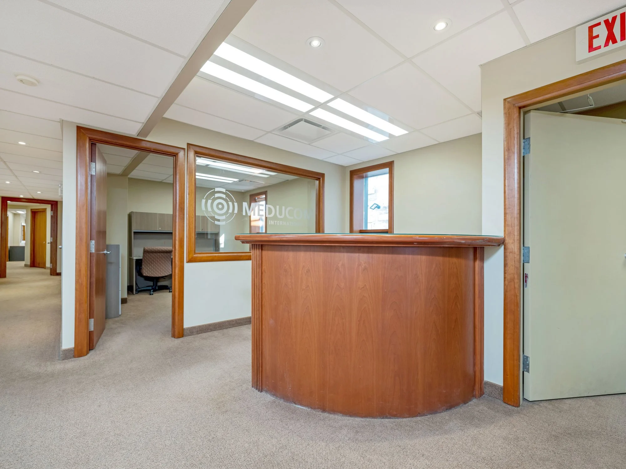 Reception desk with offices and glass partitions beyond
