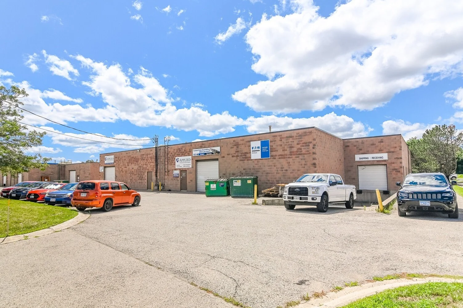 Parking area with green bins and a pickup truck at 337 Sovereign Road