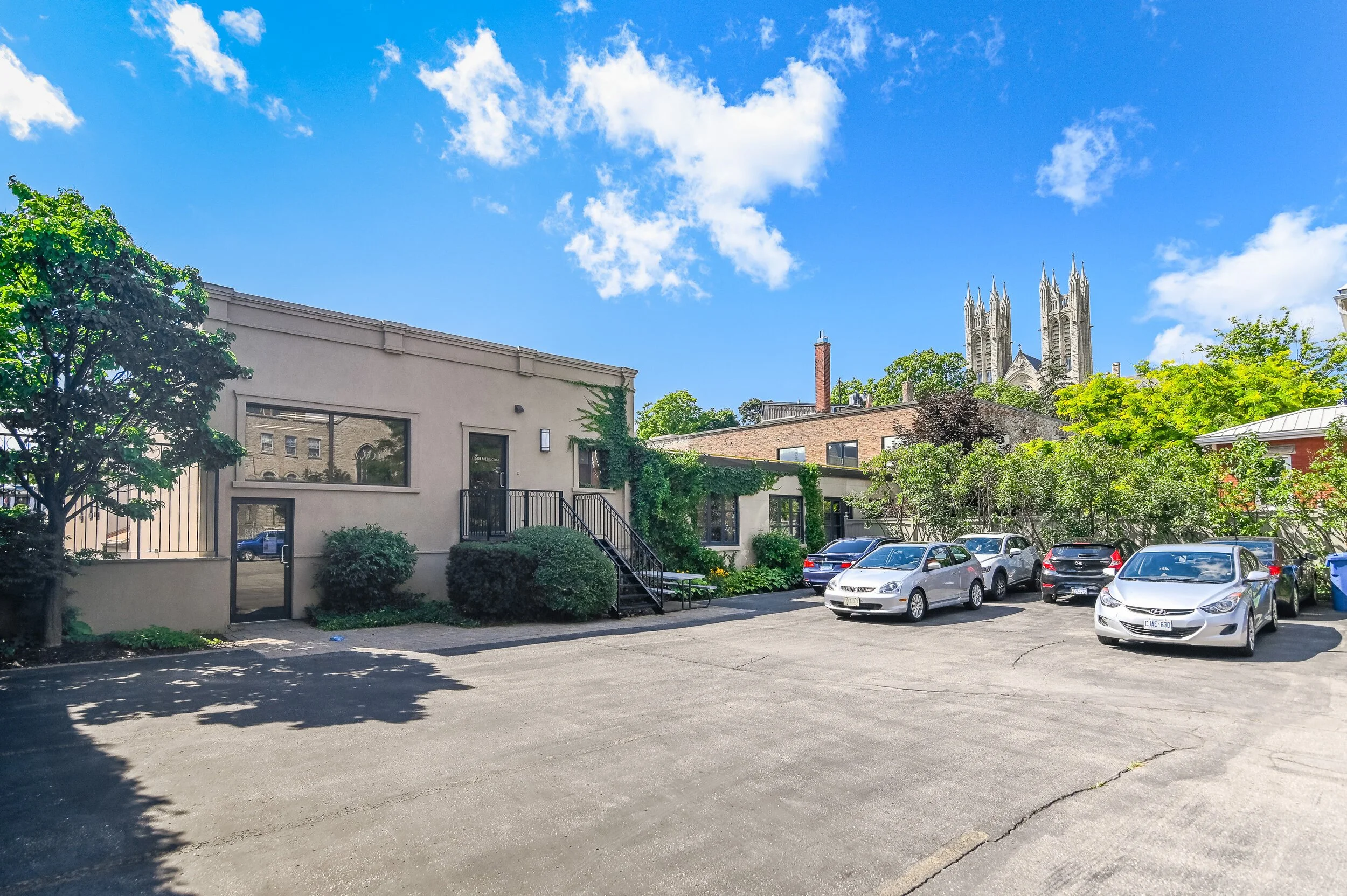 Rear parking area behind 18 Macdonell Street with parked vehicles
