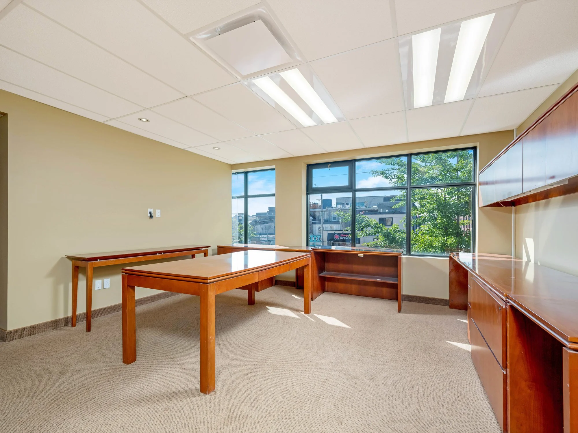 Bright office with large windows and wood desks in Unit 200 at 18 Macdonell Street