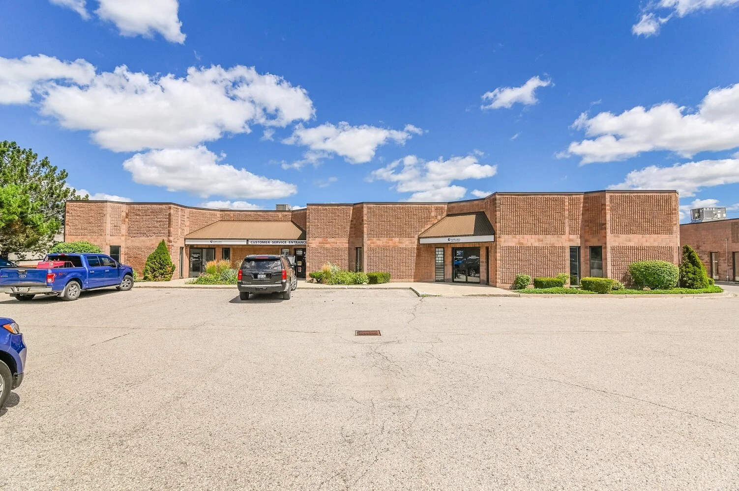 Row of brick units seen from the parking lot at 337 Sovereign Road