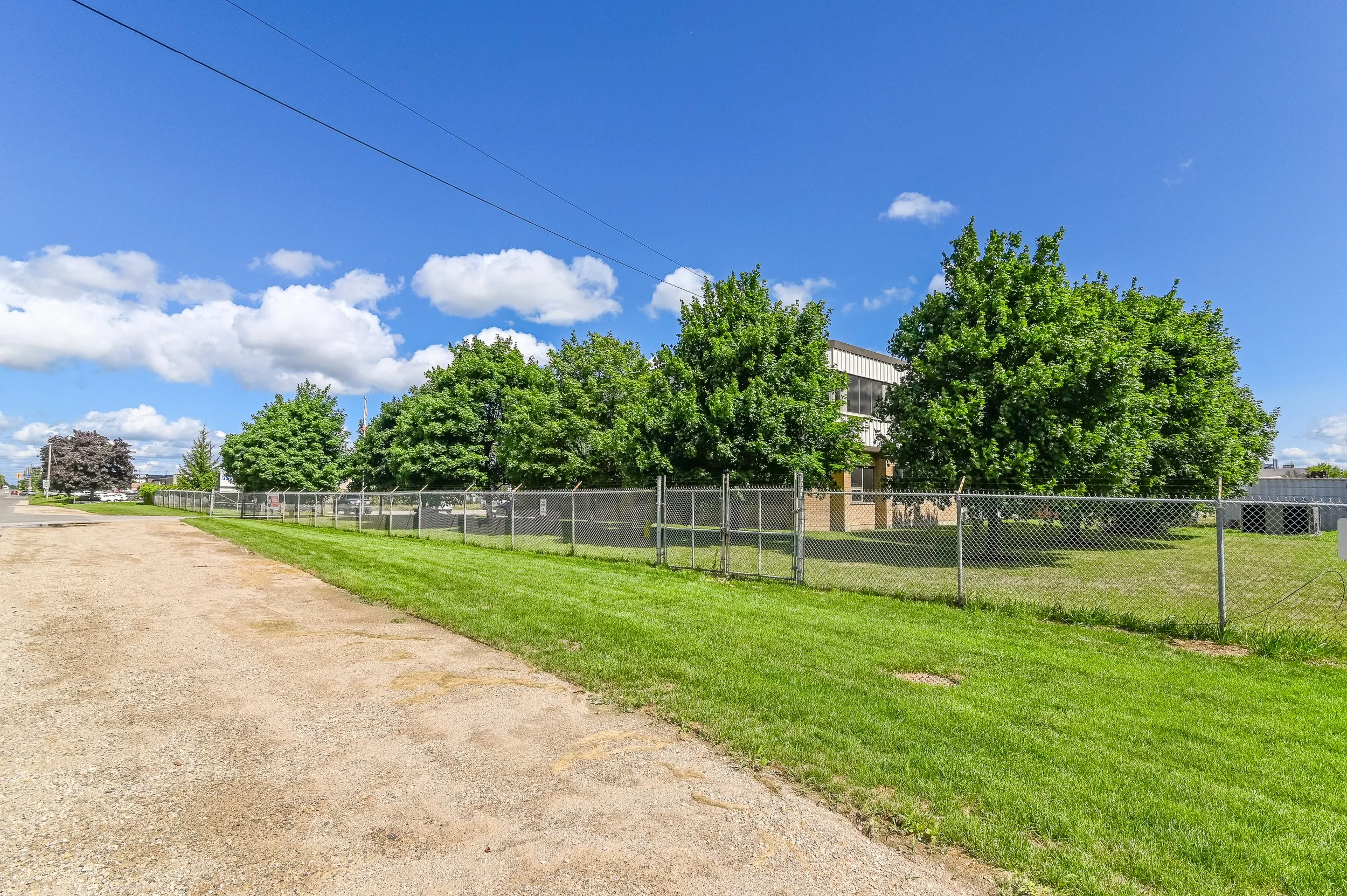 Gravel lane beside a fenced yard at 455 Silvercreek Parkway North