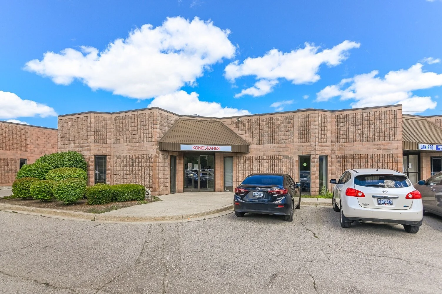 Unit entrance at 335-337 Sovereign Road with parked cars and landscaping