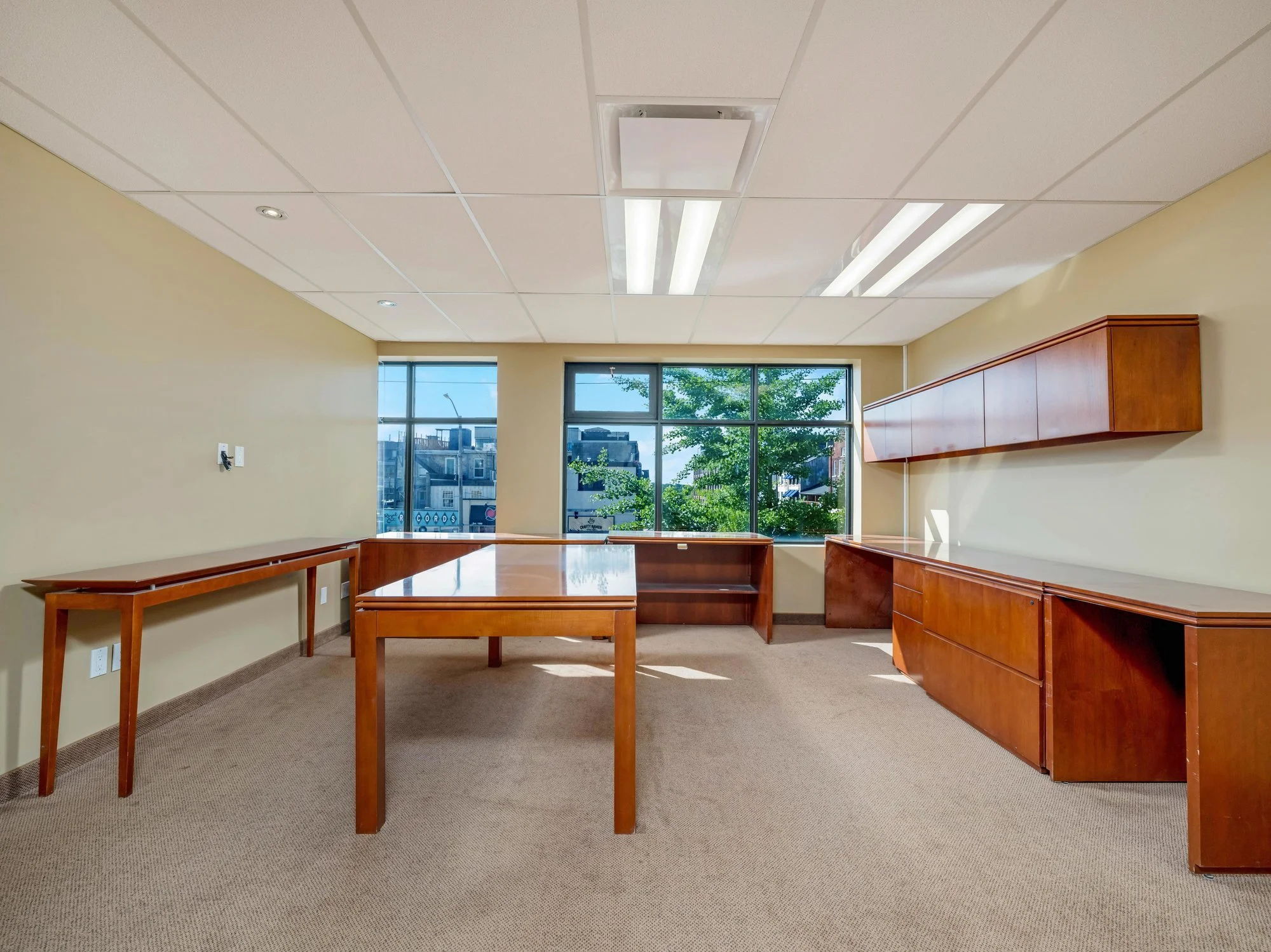 Open office with window and long wood work tables