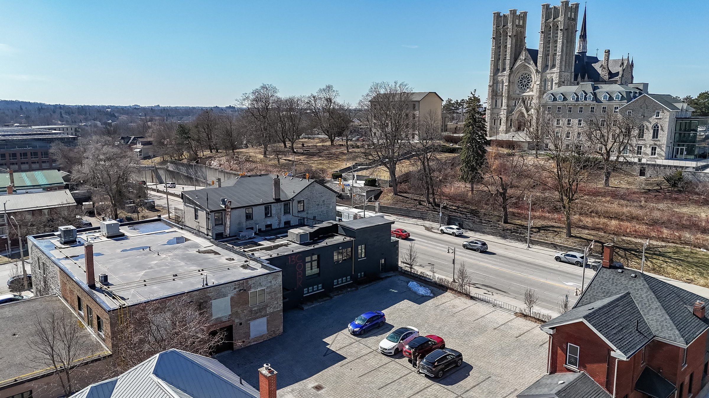 Aerial view over rooftops and the parking lot toward the cathedral, downtown Guelph