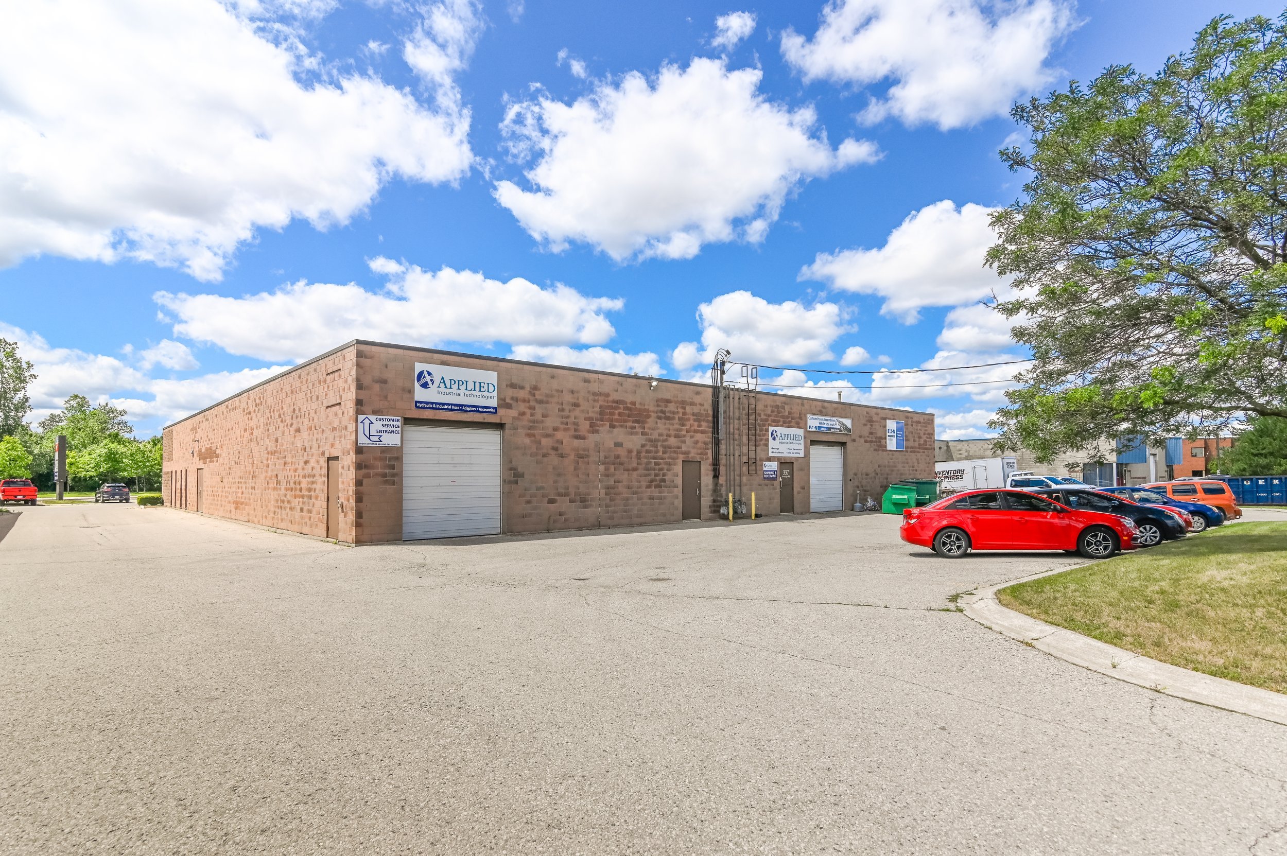 Building with a loading door and parked cars at 337 Sovereign Road