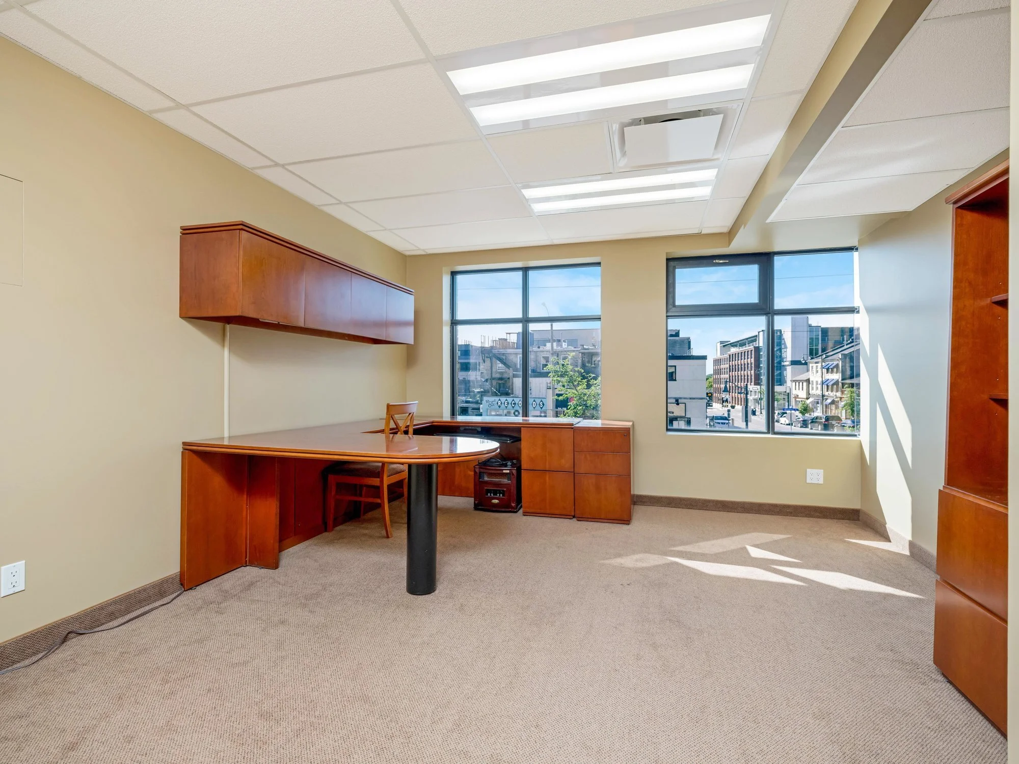 Private office with built-in wood desk and shelving