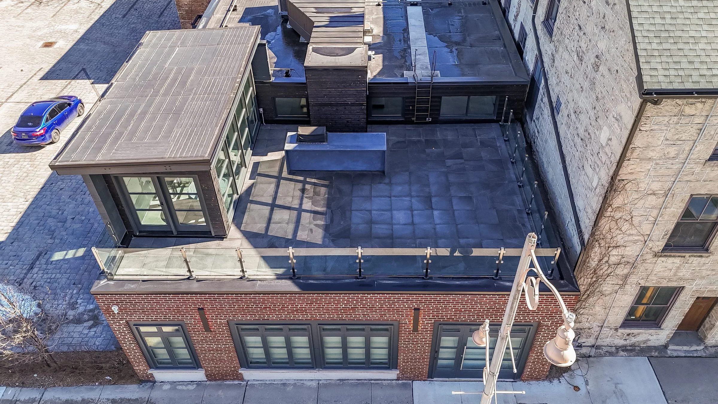 Aerial view of the private rooftop terrace with glass railing, 55 Norfolk Street, Guelph