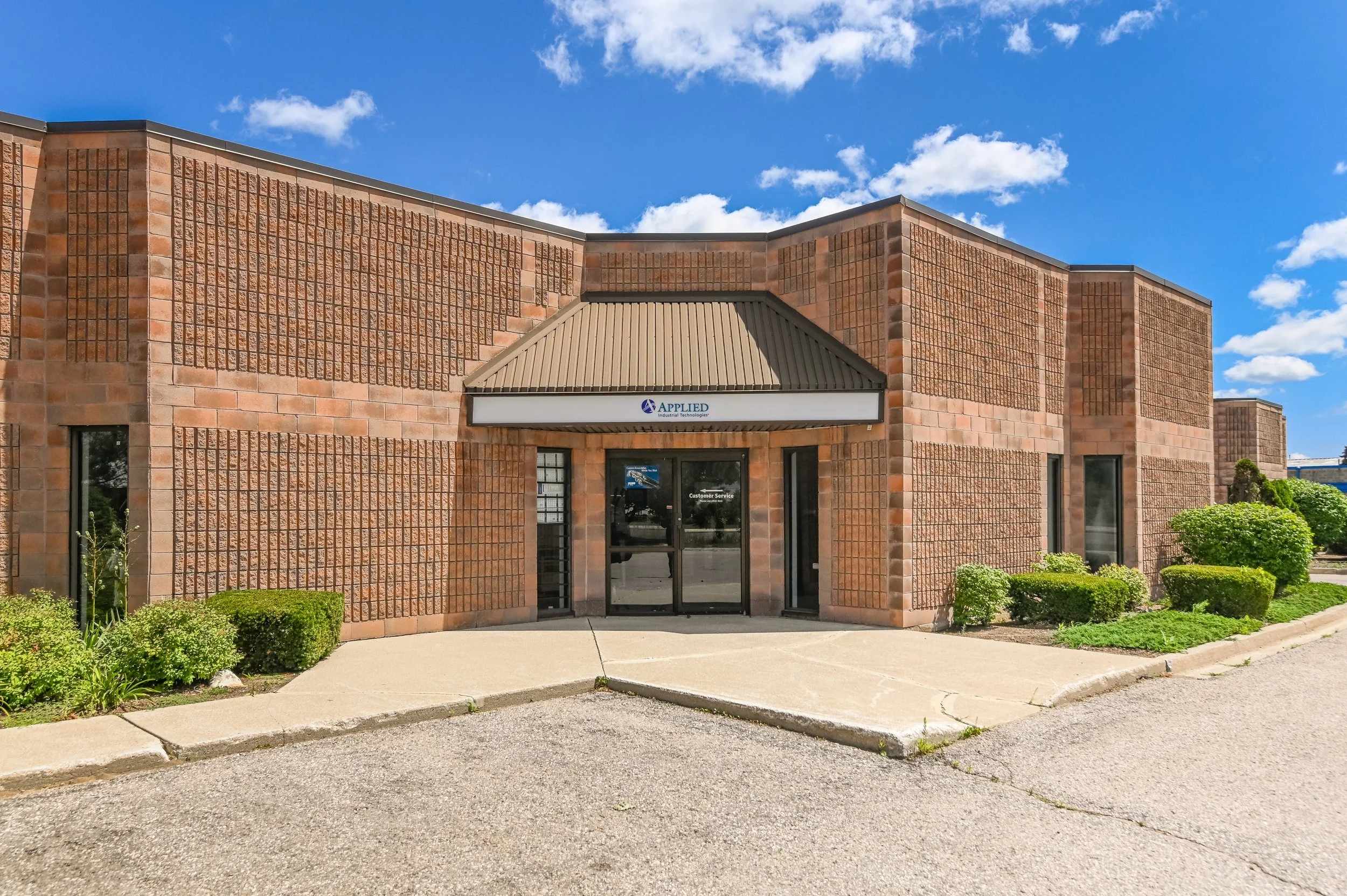 Customer service entrance with awning and brick facade at 335-337 Sovereign Road