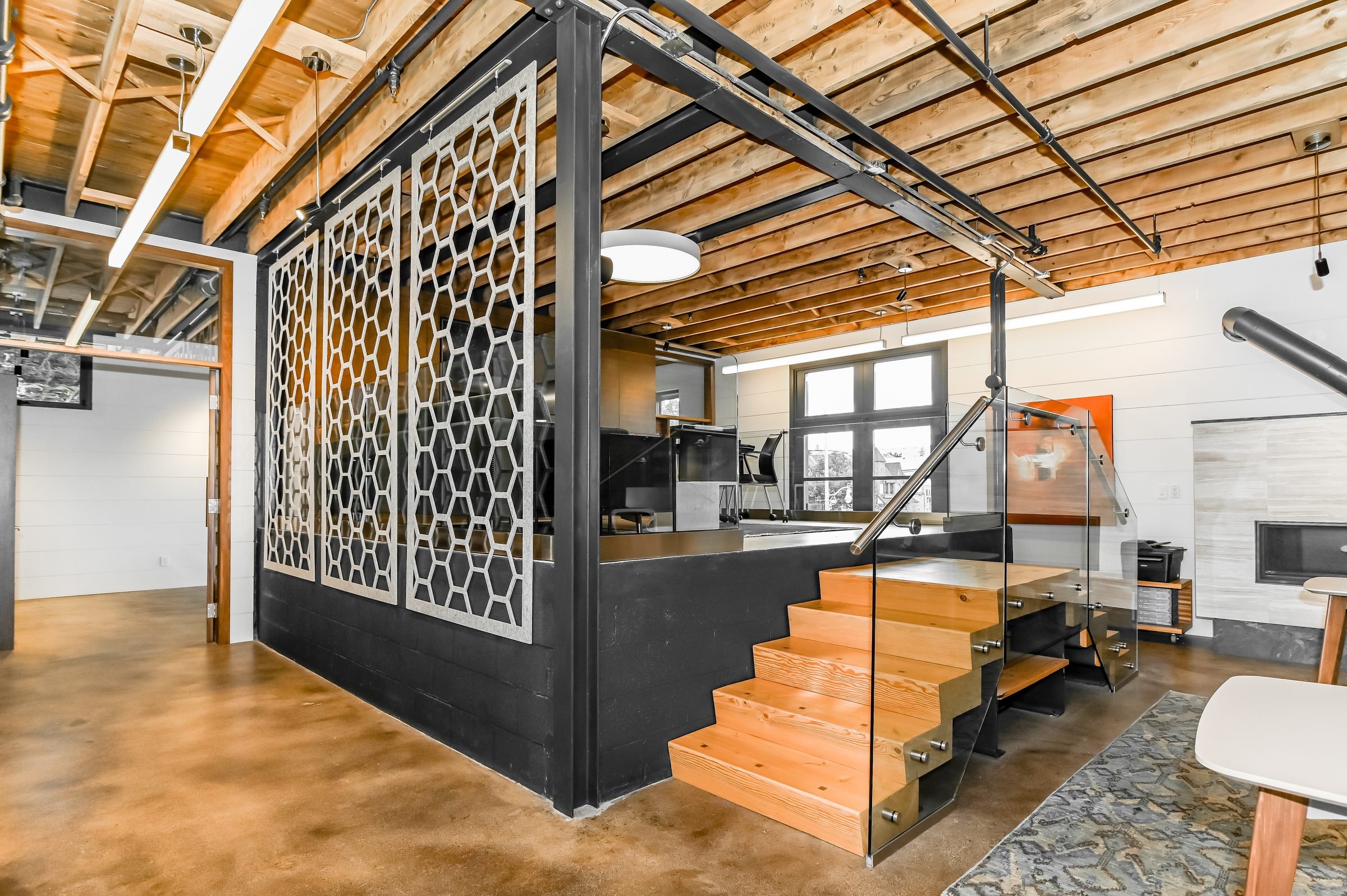 Raised workspace with wood stairs and a decorative screen, Unit 200, 13 Cork Street East