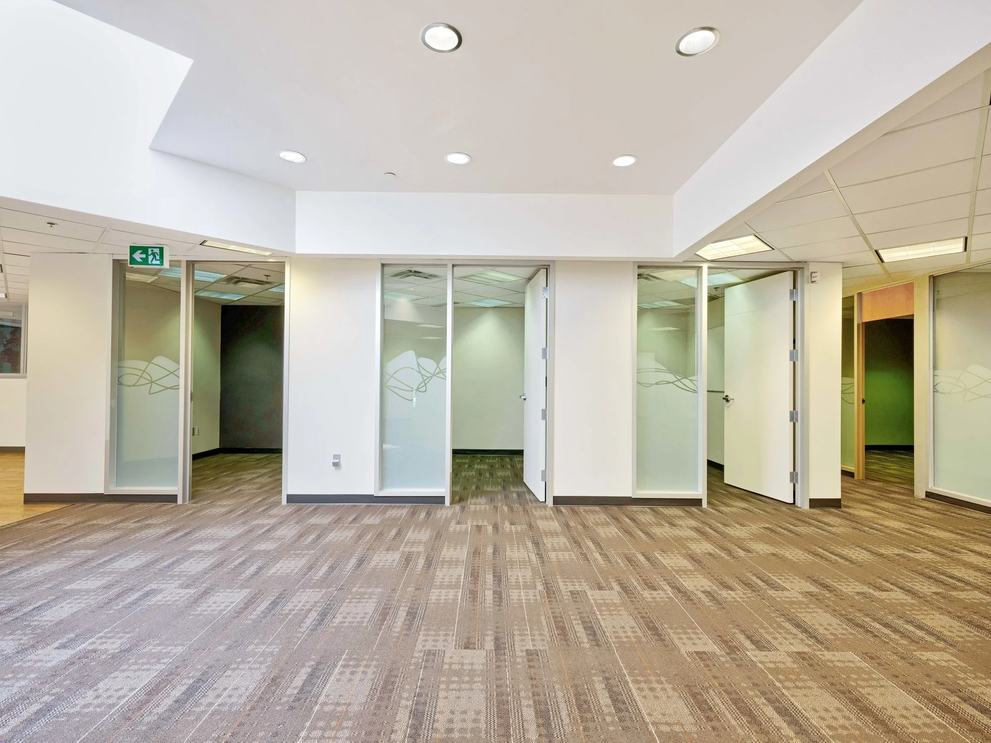 Open office floor with glass-walled offices