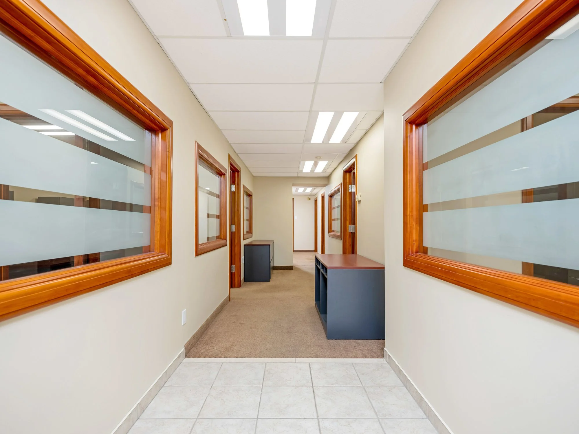 Corridor with frosted glass windows and wood trim