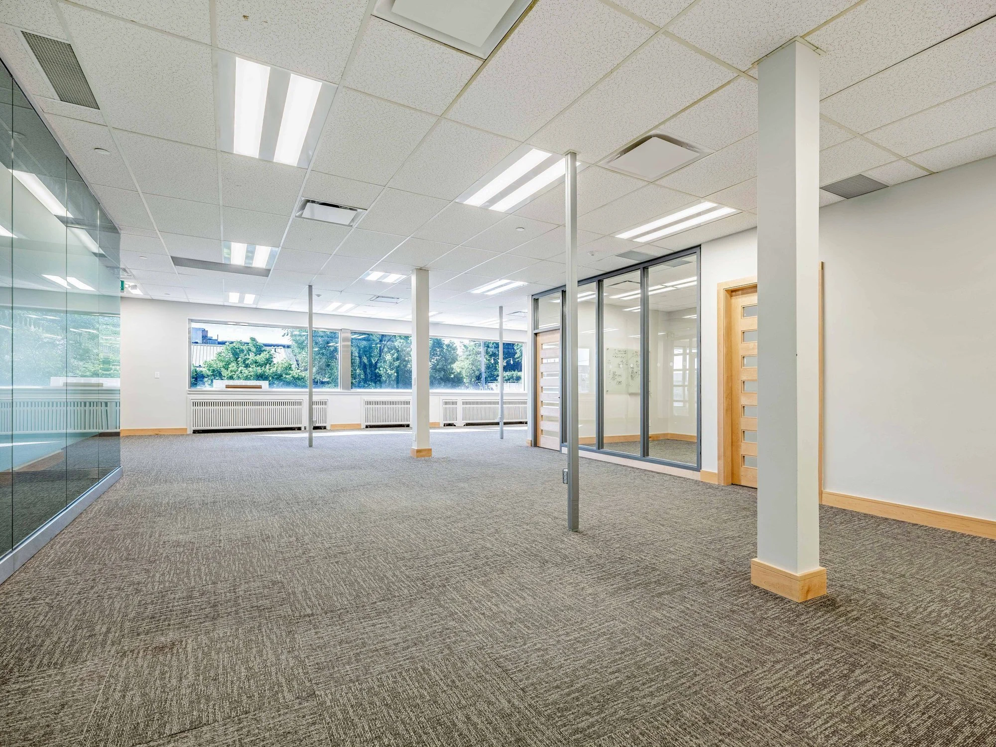 Long open office floor with columns and large windows at 8 Macdonell Street, Unit 200A, Guelph