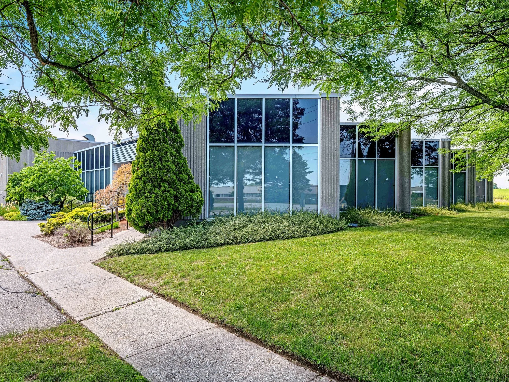 546 Governors Road front facade seen through mature trees from the sidewalk