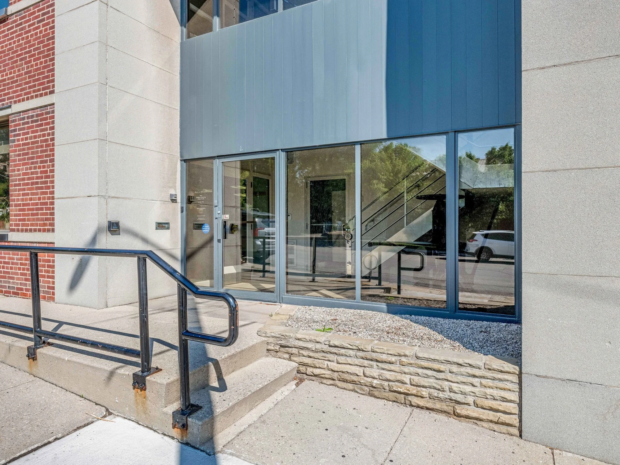 Entrance steps and metal railing at the glass front of 8 Macdonell Street, Guelph
